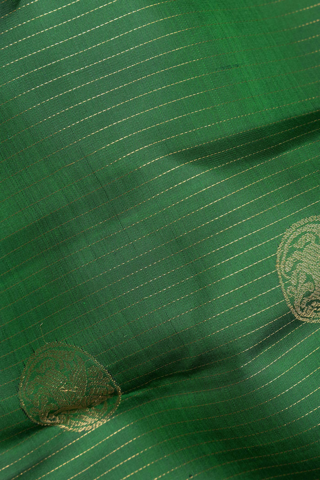 Close up of Pure Silk Green Kanjivaram Saree with Stripes on the body and Zari Border.  displaying folds