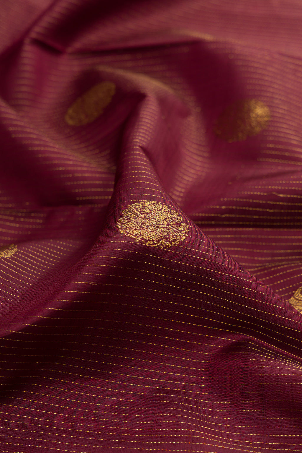 Close up of Coffee Brown Kanjivaram Silk Saree with Stripes on the body and Zari Border.  displaying folds