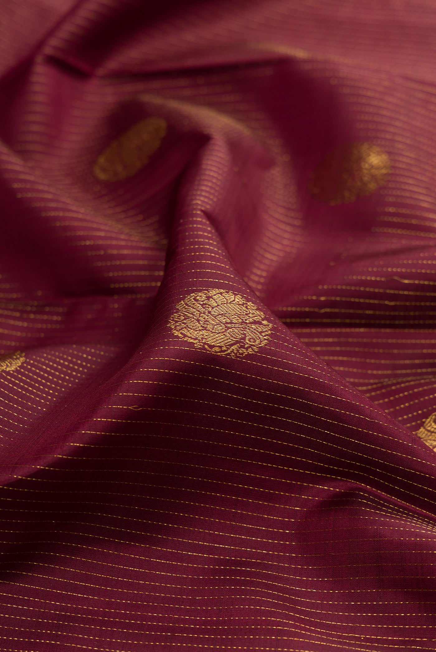 Close up of Coffee Brown Kanjivaram Silk Saree with Stripes on the body and Zari Border.  displaying folds