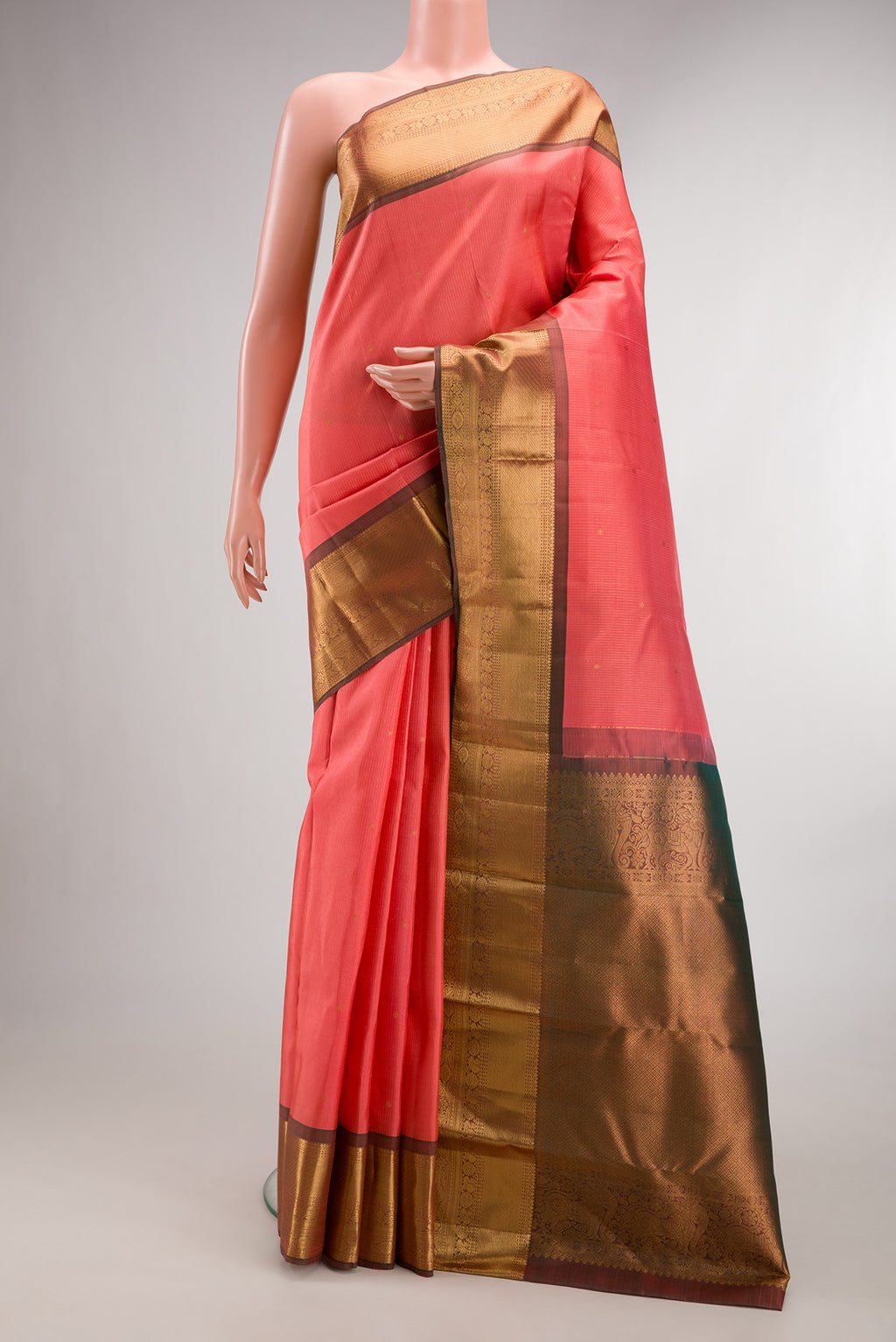 Pure Silk Coral Kanjivaram Saree with Stripes on the body and Zari Border.  displayed on a mannequin