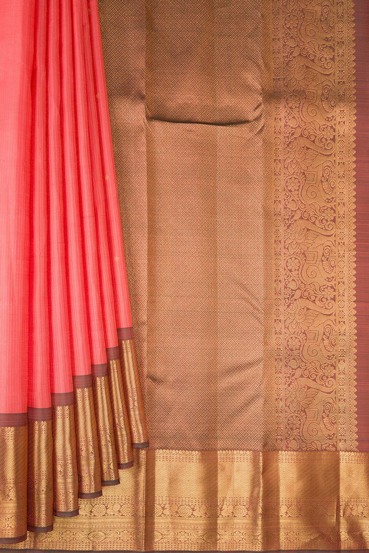 Pleats and pallu of Pure Silk Coral Kanjivaram Saree with Stripes on the body and Zari Border. 