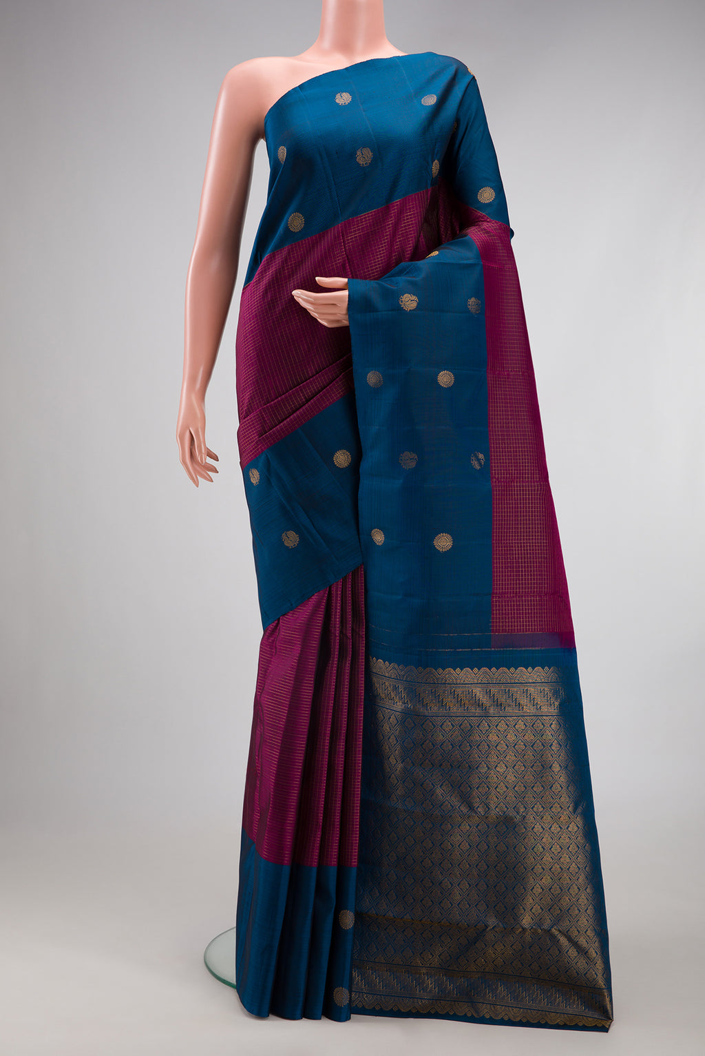 Magenta Kanjivaram Silk Saree with Checked design on the body and Fancy Border.  displayed on a mannequin