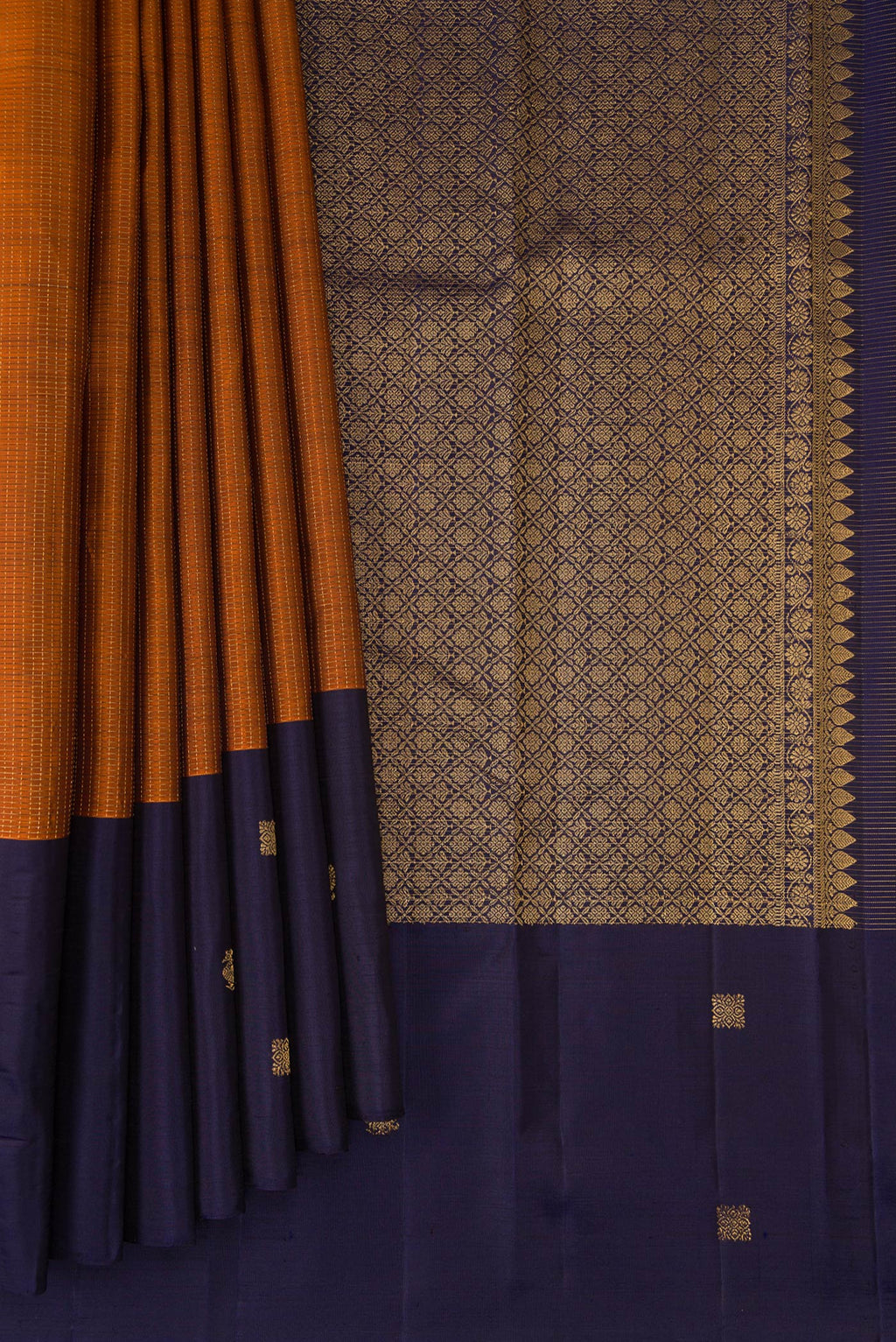 Pleats and pallu of Rust Kanjivaram Silk Saree with Checked design on the body and Fancy Border. 
