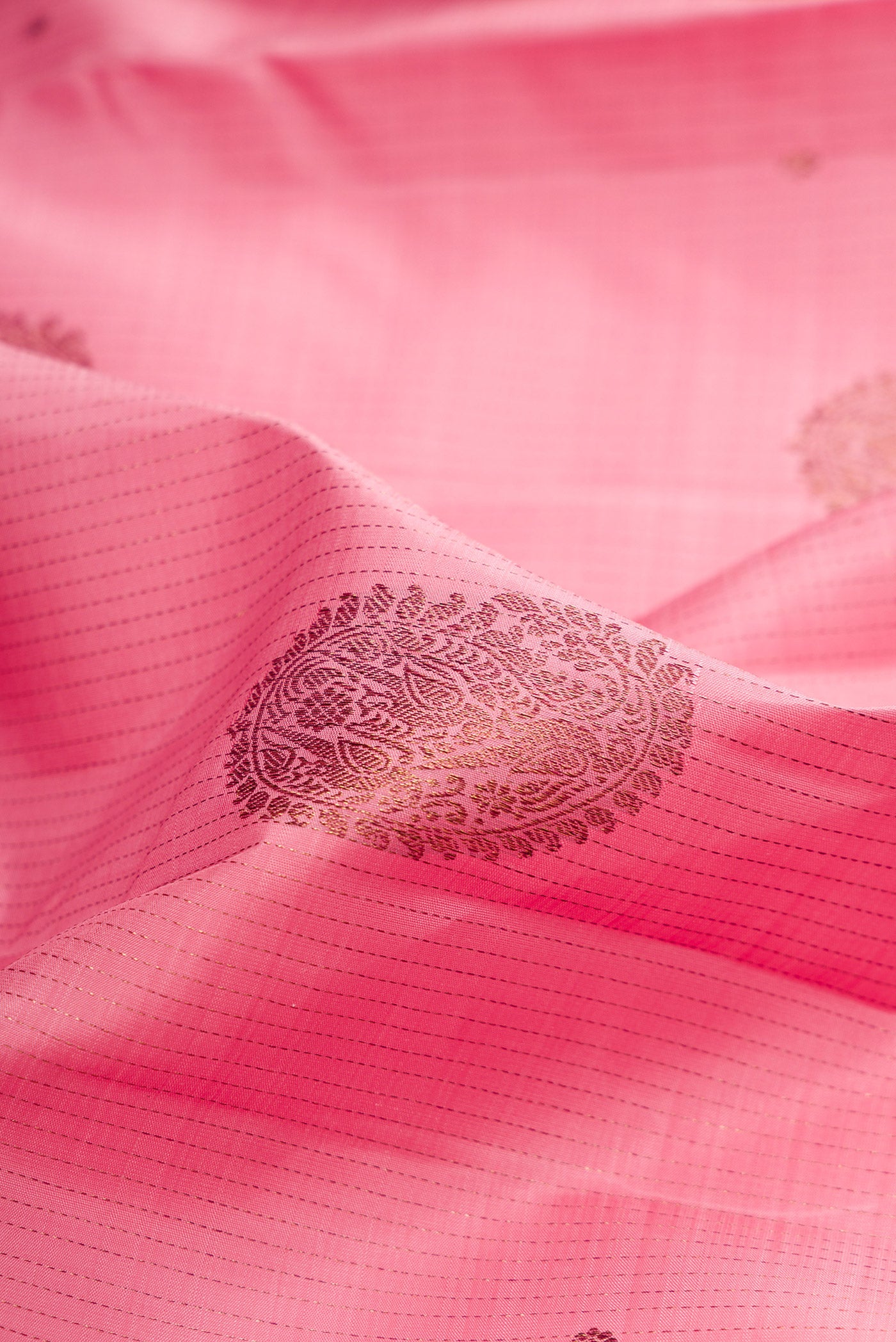 Close up of Pink Kanjivaram Silk Saree with Stripes on the body and Without Border.  displaying folds
