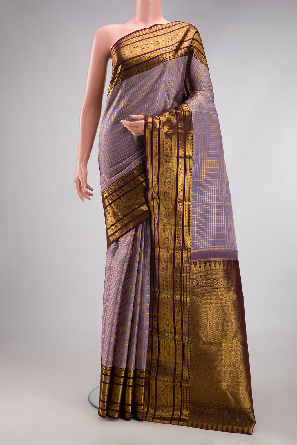 Lavender Dual Tone Kanjivaram Silk Saree with Checked design on the body and Zari Border.  displayed on a mannequin