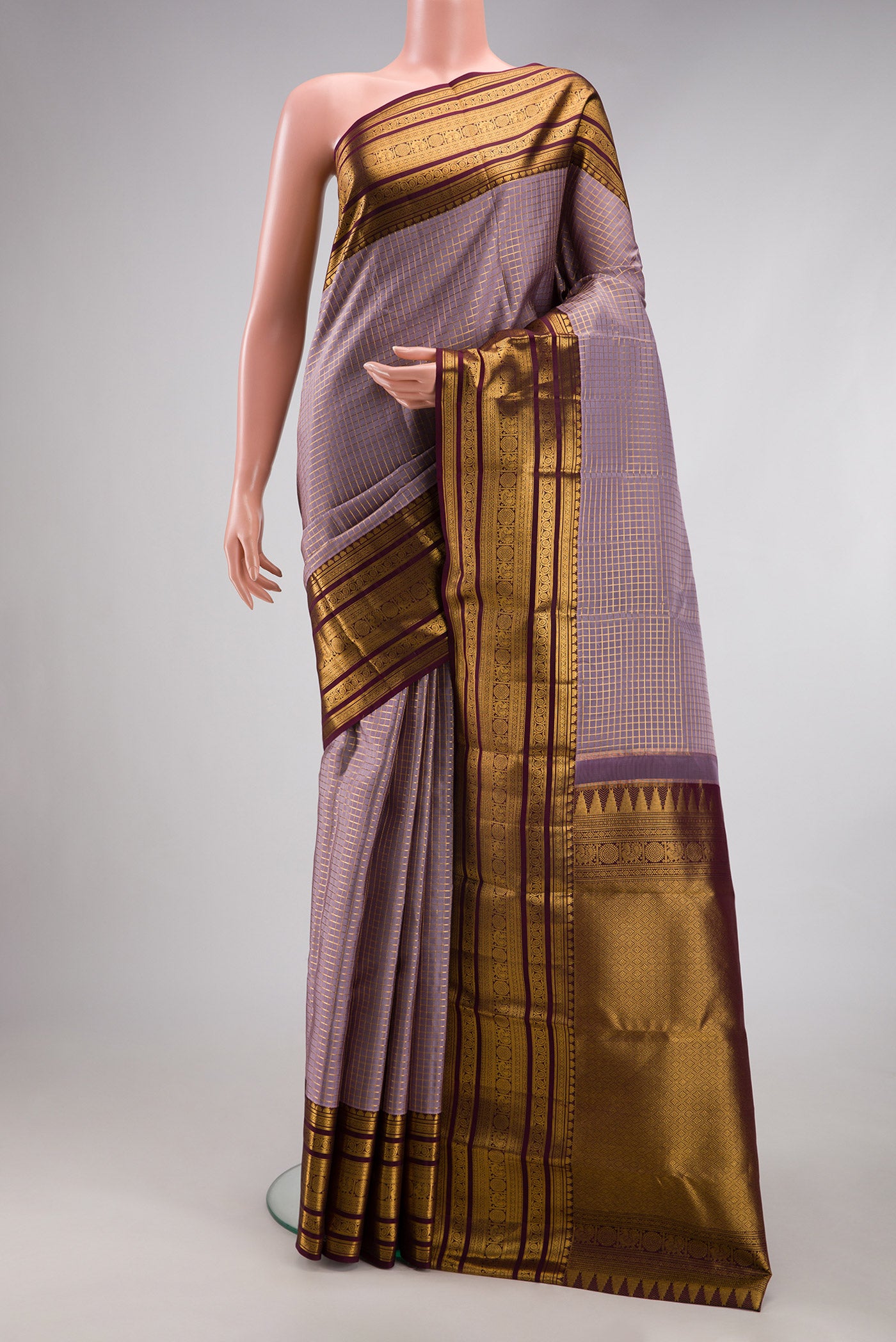 Lavender Dual Tone Kanjivaram Silk Saree with Checked design on the body and Zari Border.  displayed on a mannequin