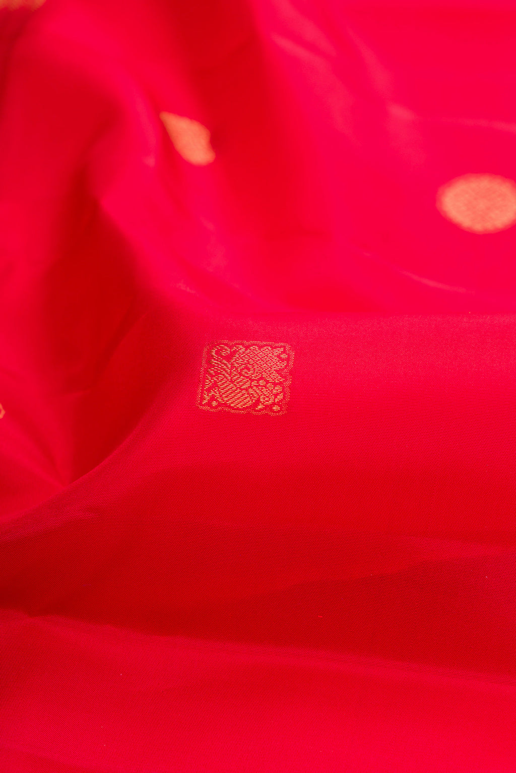 Close up of Red Kanchipuram Silk Saree with Zari Butta on the body and Fancy Border.  displaying folds