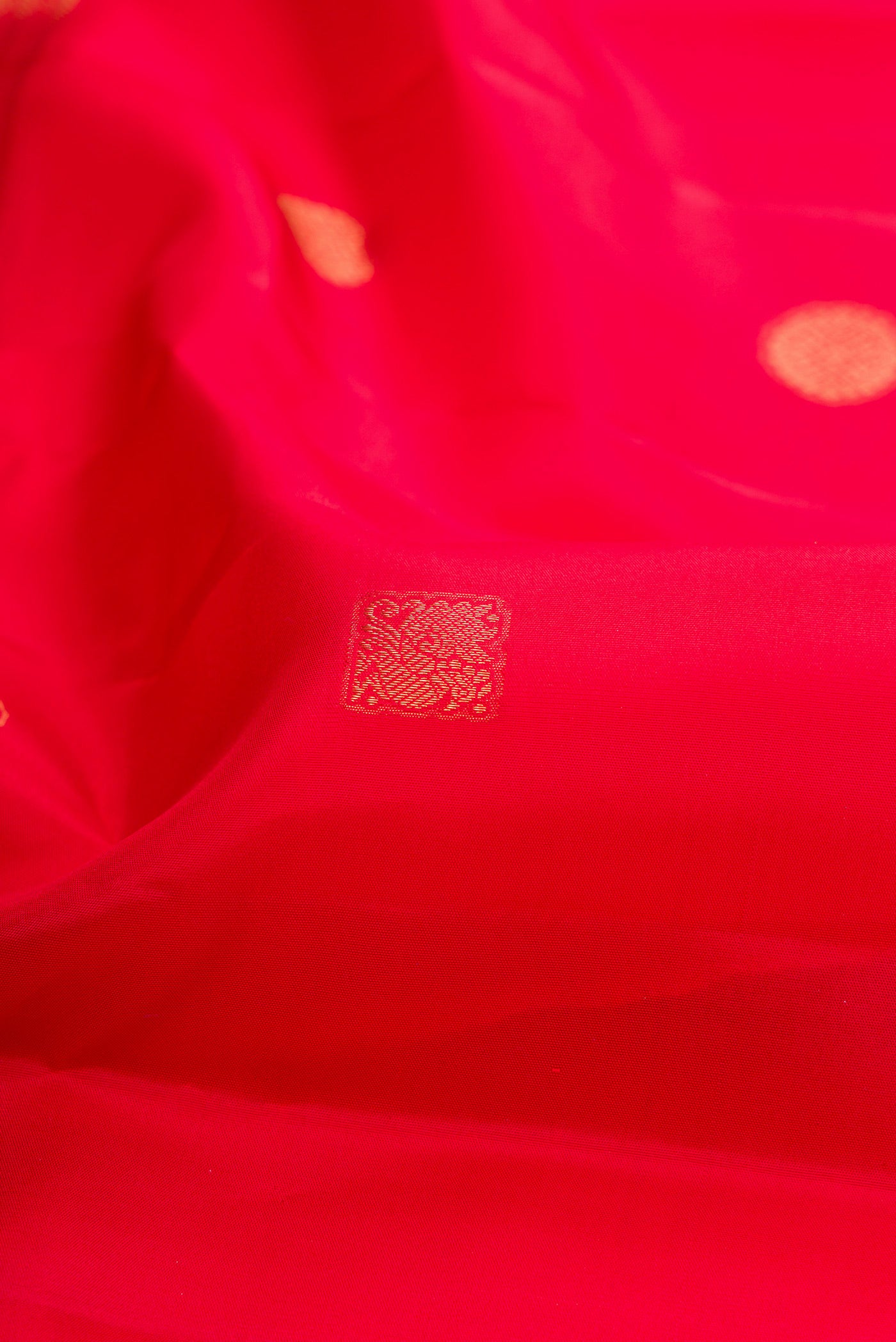 Close up of Red Kanchipuram Silk Saree with Zari Butta on the body and Fancy Border.  displaying folds