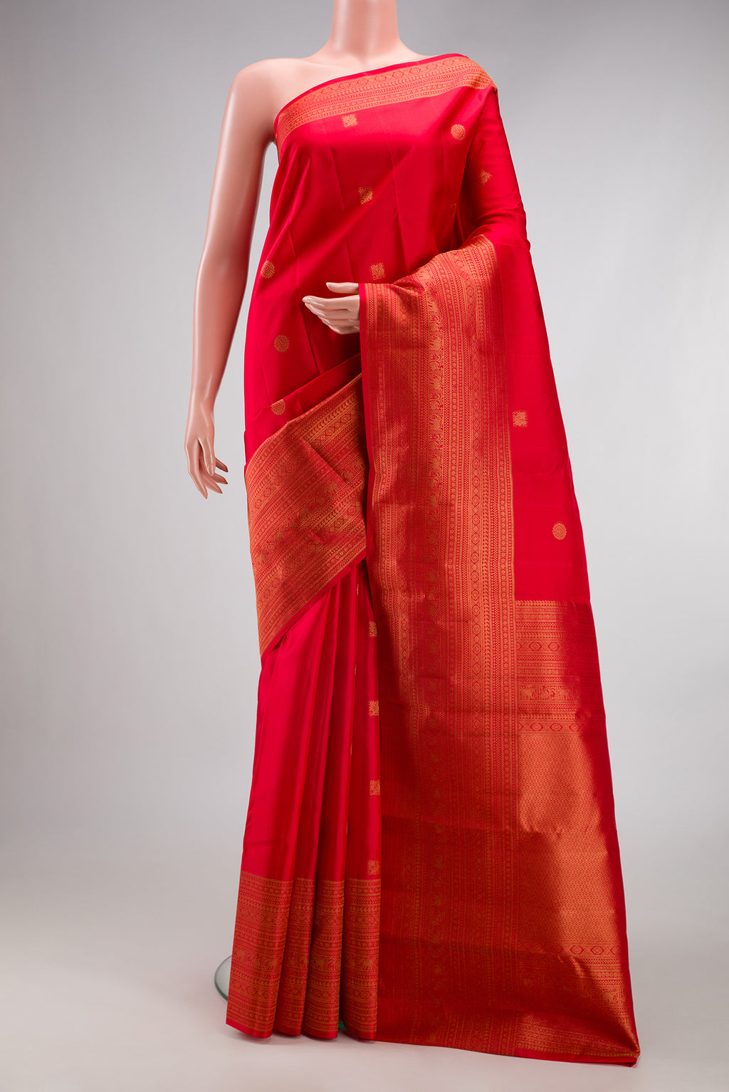 Red Kanchipuram Silk Saree with Zari Butta on the body and Fancy Border.  displayed on a mannequin