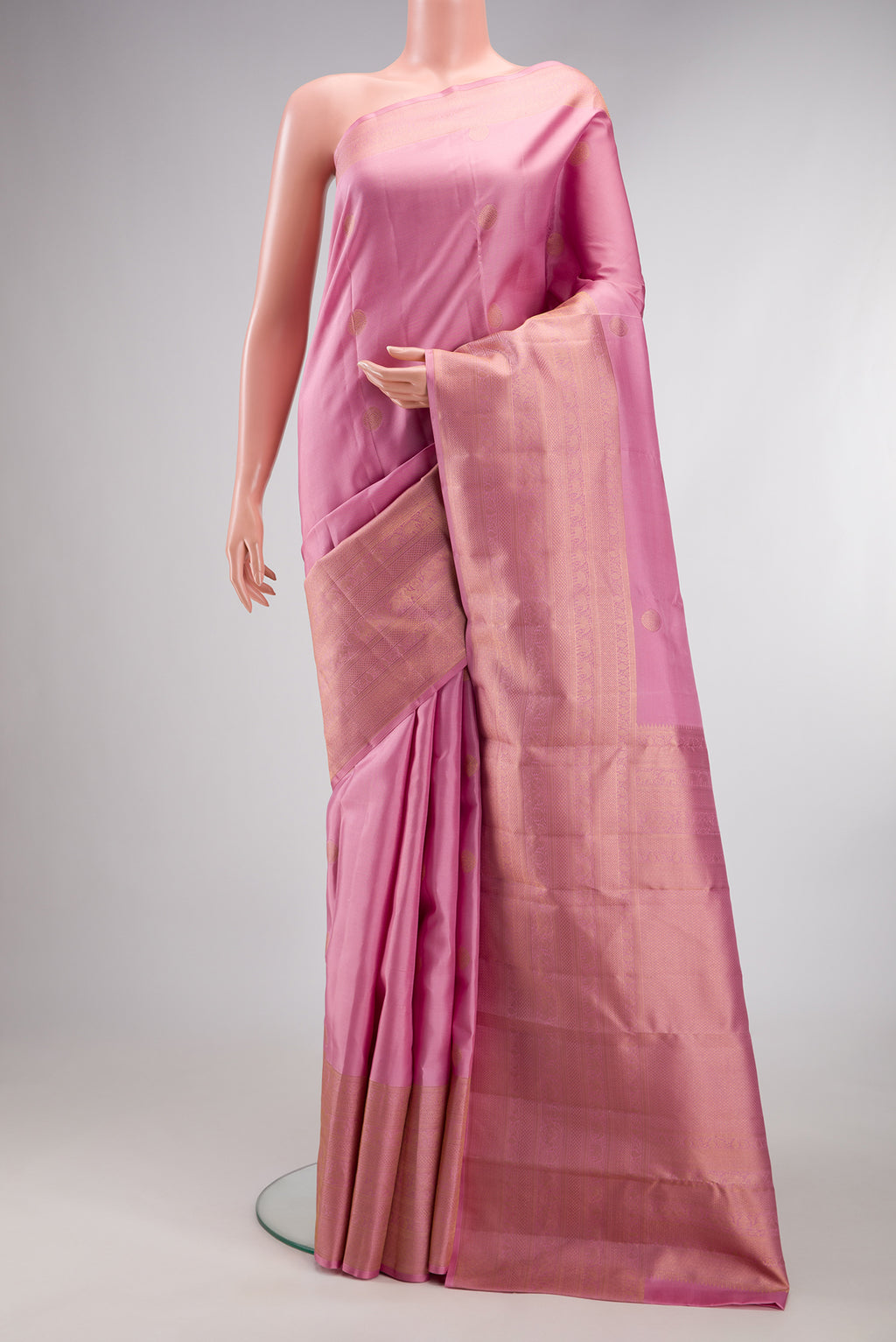 Pure Silk Rose pink Kanchipuram Saree with Zari Butta on the body and Fancy Border.  displayed on a mannequin