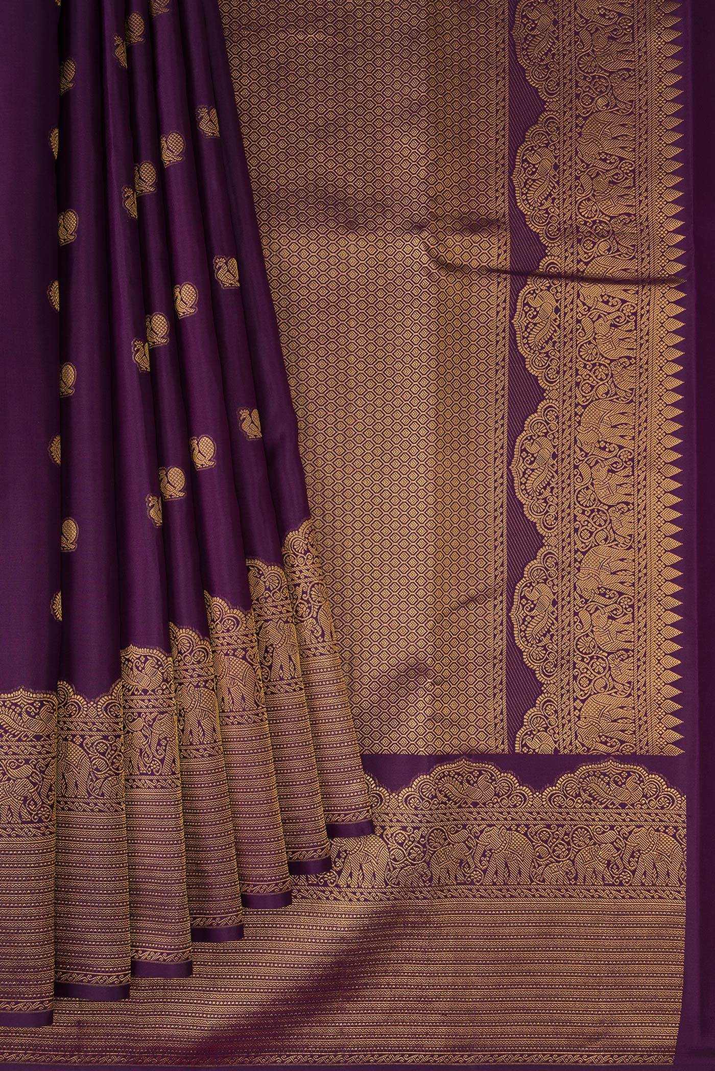 Pleats and pallu of Burgundy Kanchipuram Silk Saree with Zari Butta on the body and Fancy Border. 