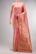 Pure Silk Peach Kanchipuram Saree with Zari Butta on the body and Zari Border.  displayed on a mannequin