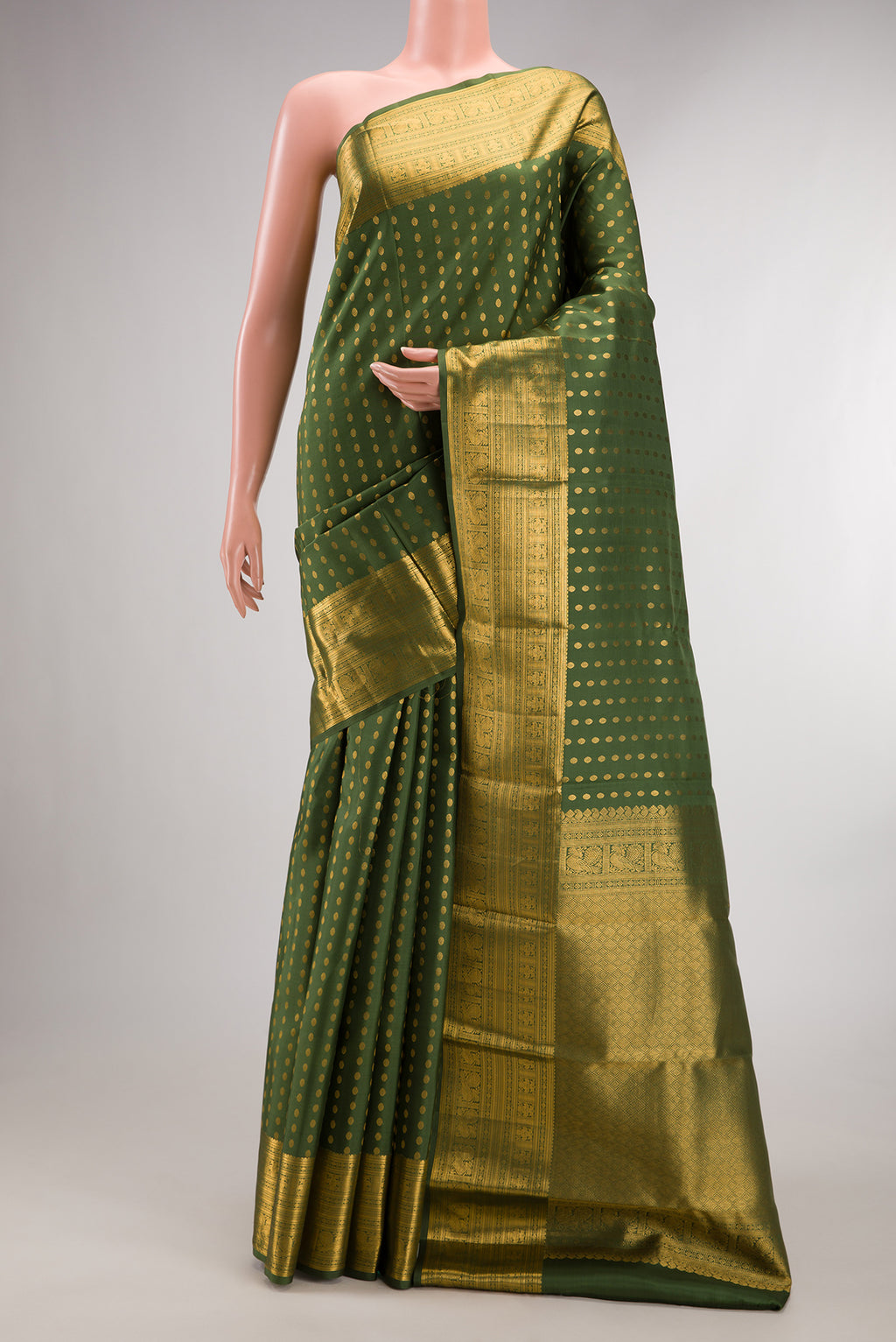 Pure Silk Mehandi Green Kanchipuram Saree with Zari Butta on the body and Zari Border.  displayed on a mannequin