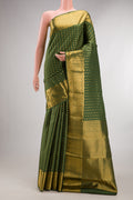 Pure Silk Mehandi Green Kanchipuram Saree with Zari Butta on the body and Zari Border.  displayed on a mannequin