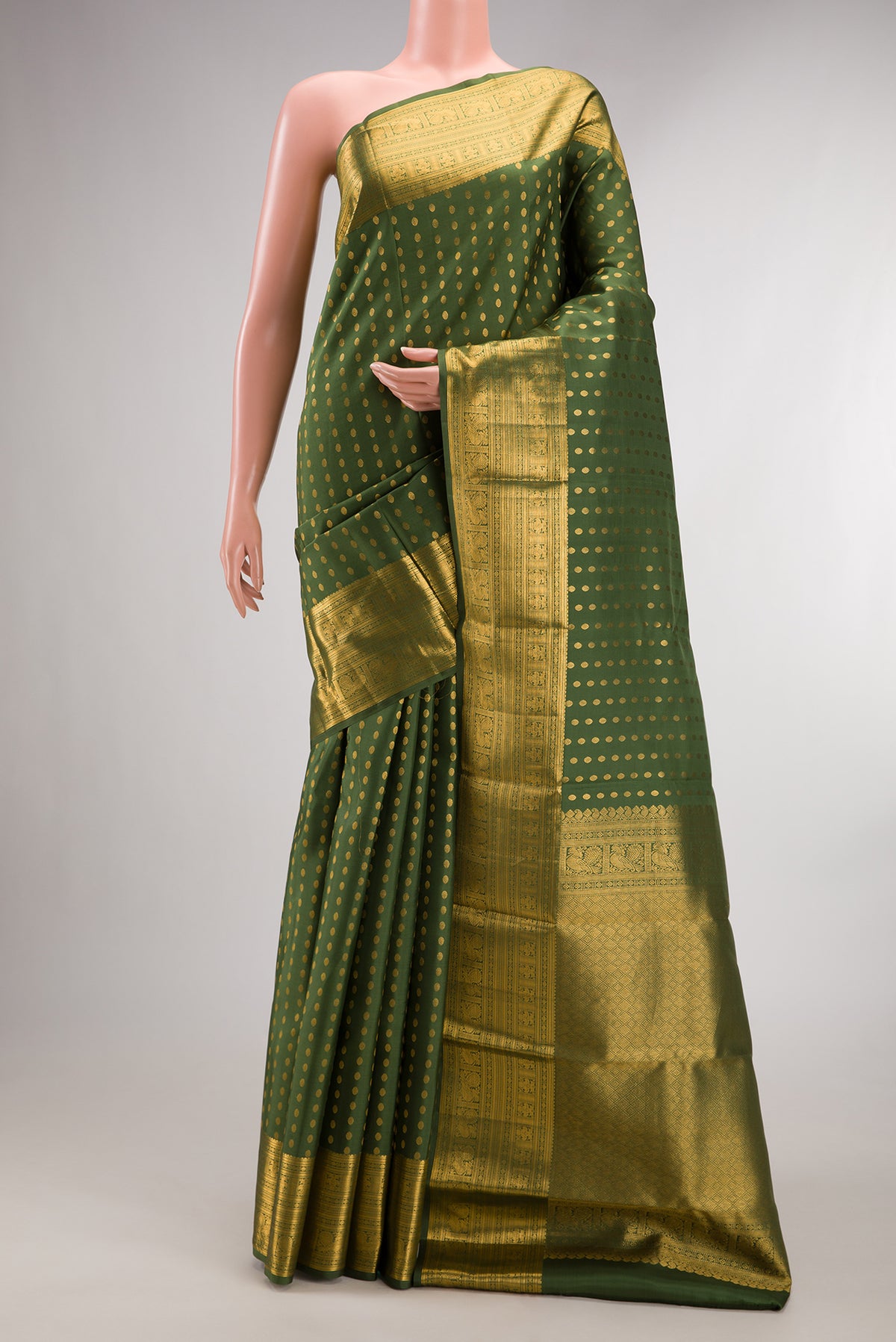 Pure Silk Mehandi Green Kanchipuram Saree with Zari Butta on the body and Zari Border.  displayed on a mannequin