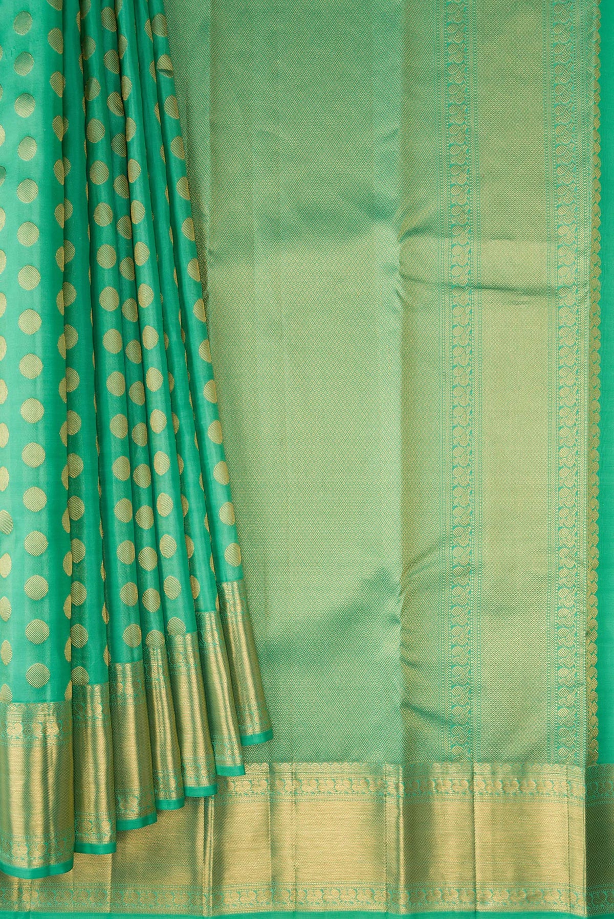 Pleats and pallu of Pure Silk Green Kanchipuram Saree with Zari Butta on the body and Zari Border. 