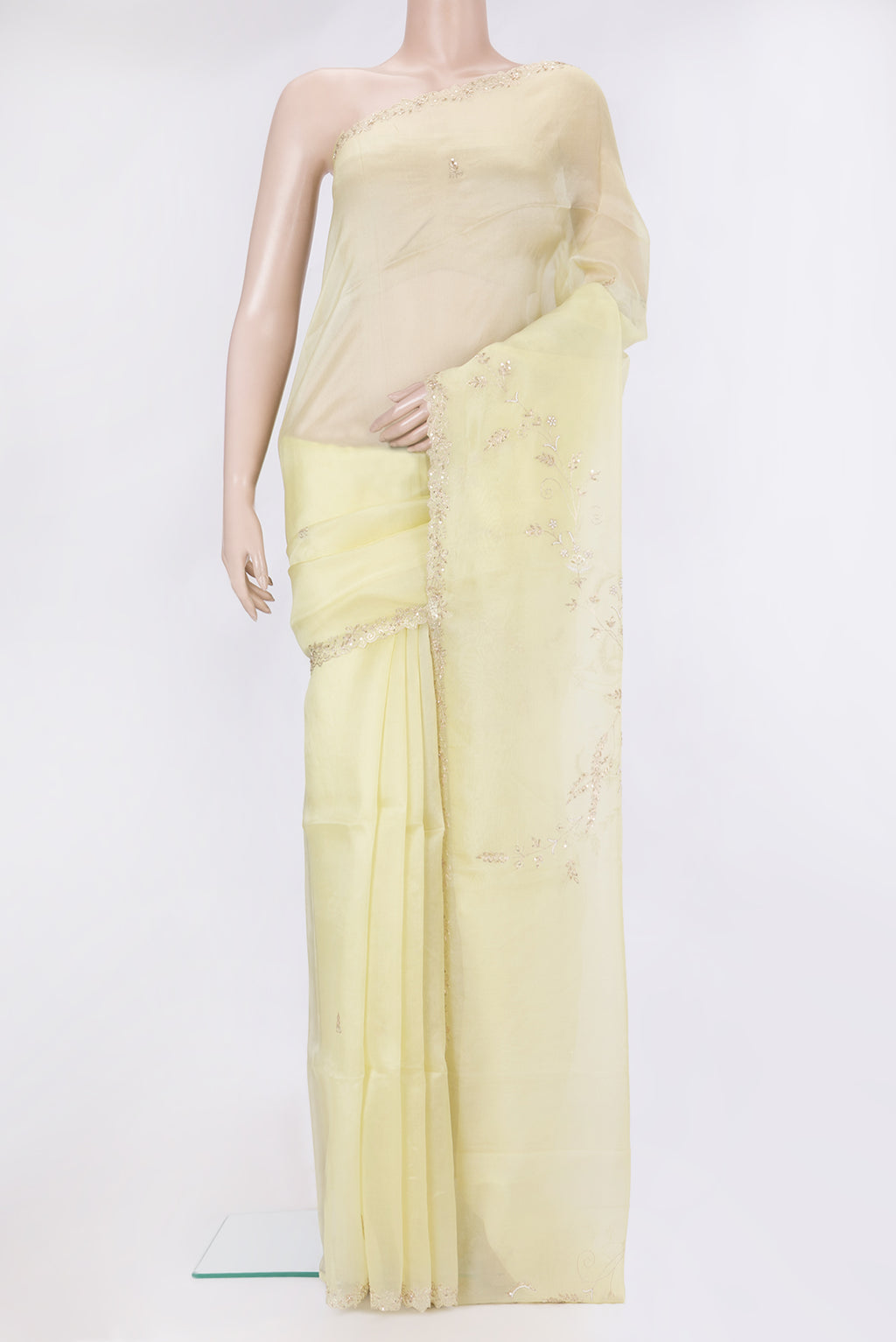 Lemon Yellow Organza Silk Saree with Embroidery on the body and Sequin Border.  displayed on a mannequin