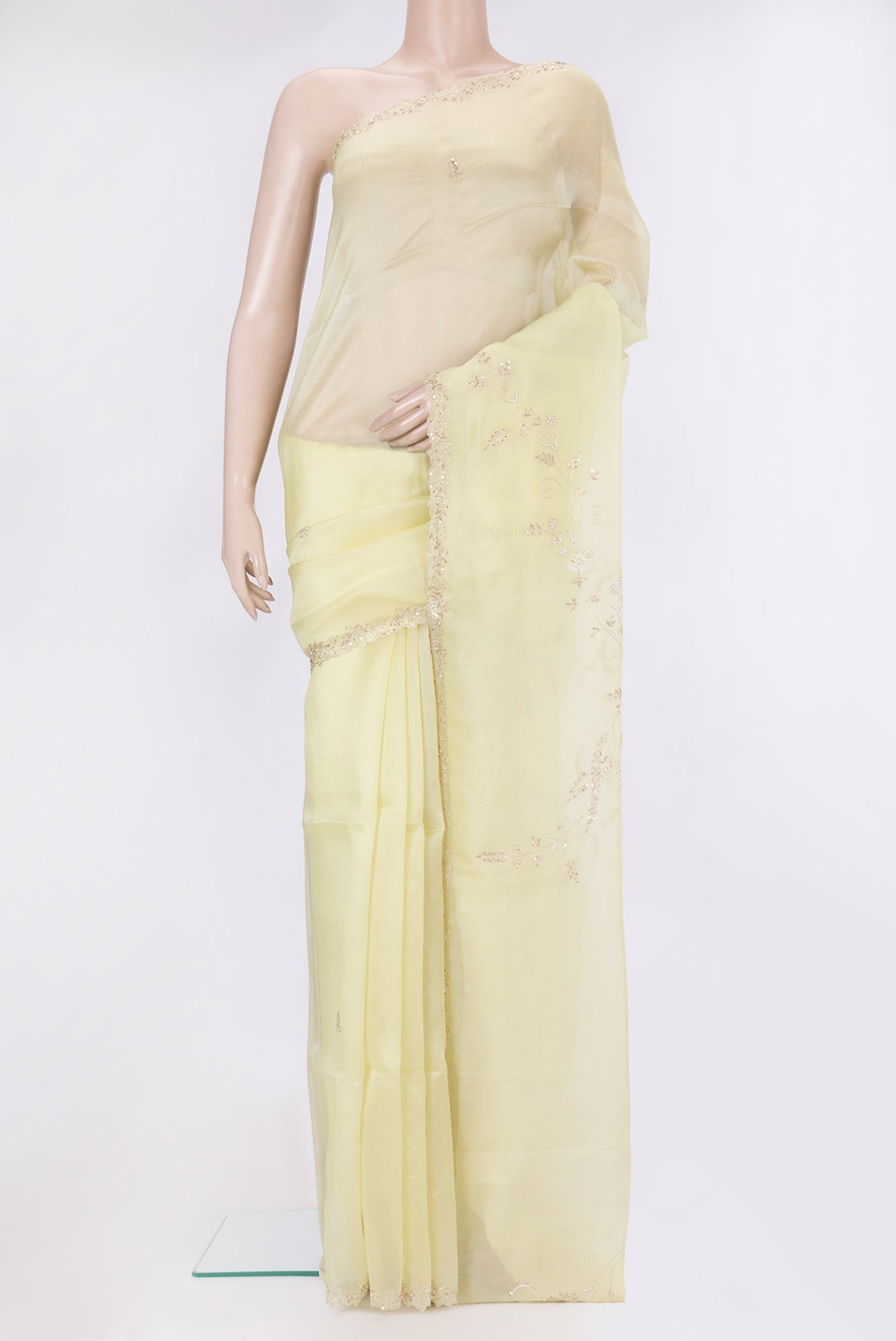 Lemon Yellow Organza Silk Saree with Embroidery on the body and Sequin Border.  displayed on a mannequin