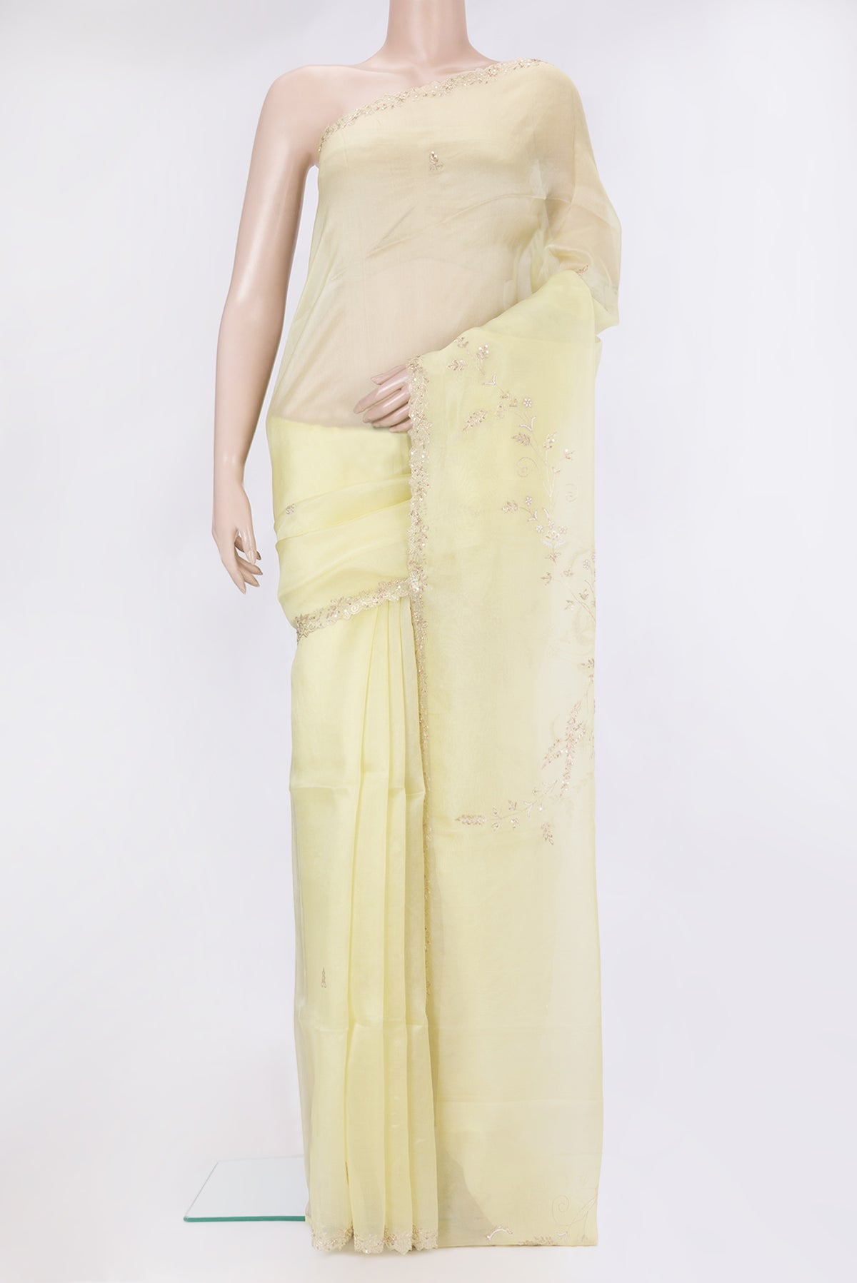 Lemon Yellow Organza Silk Saree with Embroidery on the body and Sequin Border.  displayed on a mannequin