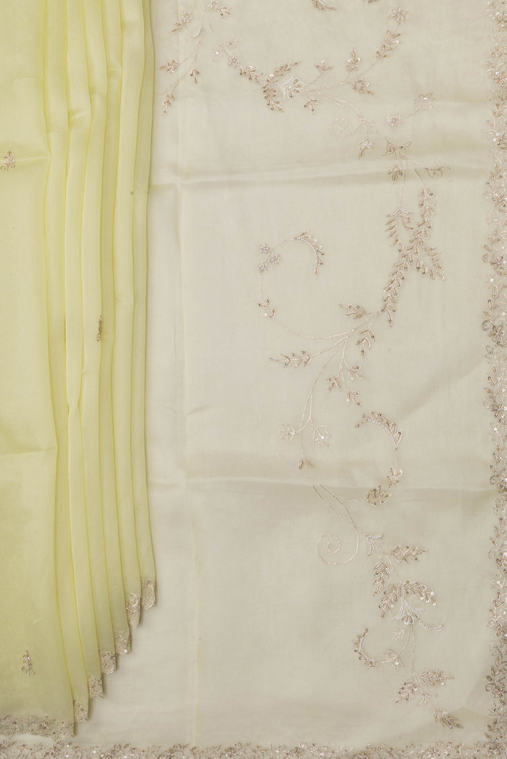 Pleats and pallu of Lemon Yellow Organza Silk Saree with Embroidery on the body and Sequin Border. 