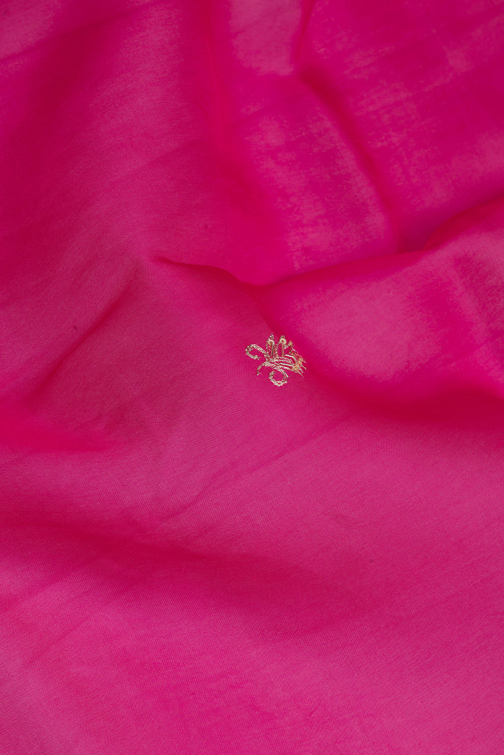Close up of Rani Pink Organza Silk Saree with Embroidery on the body and Embroidery Border.  displaying folds
