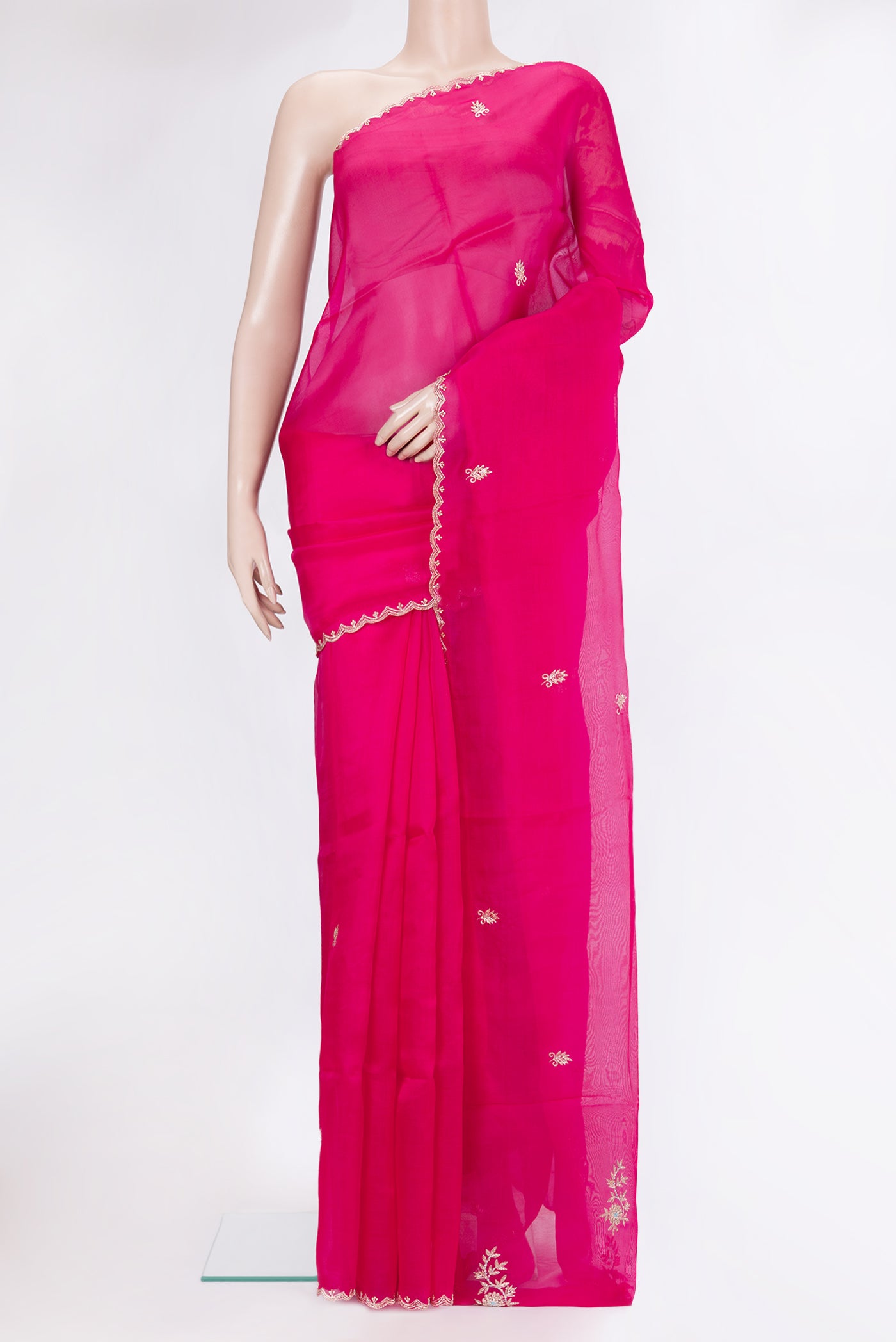 Rani Pink Organza Silk Saree with Embroidery on the body and Embroidery Border.  displayed on a mannequin