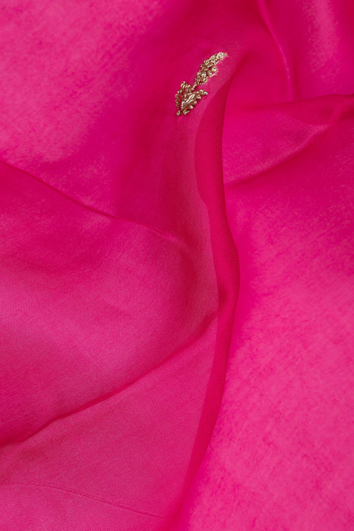 Close up of Dark Pink Dual Tone Organza Saree with Embroidery on the body and Embroidery Border.  displaying folds