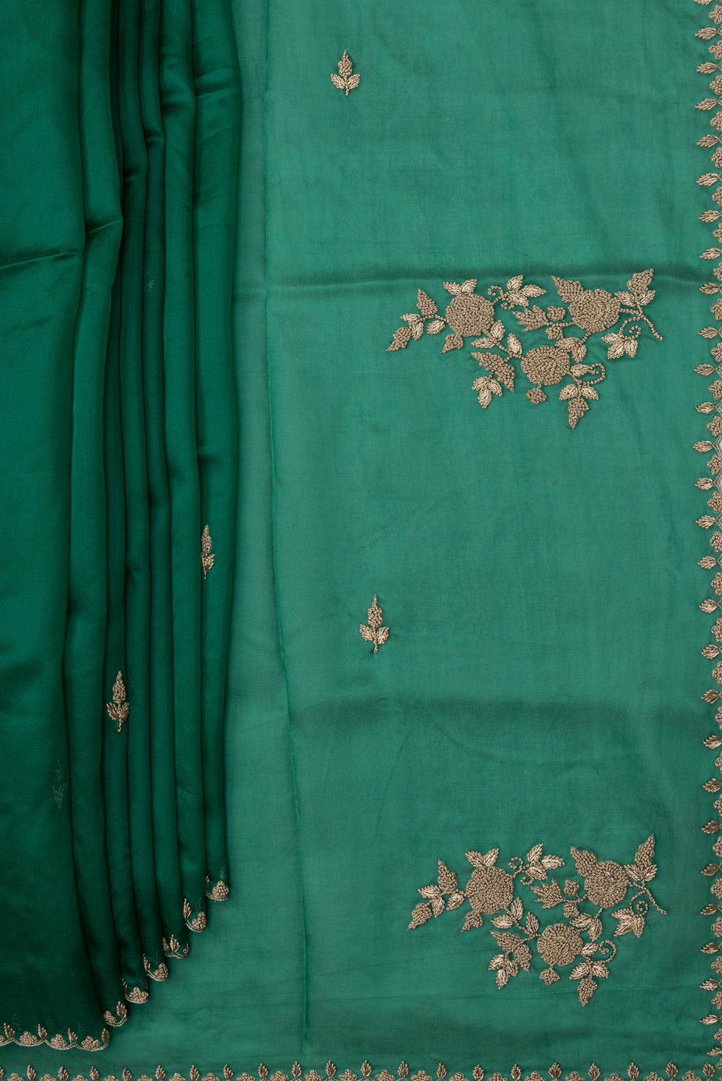 Pleats and pallu of Green Organza Silk Saree with Embroidery on the body and Embroidery Border. 