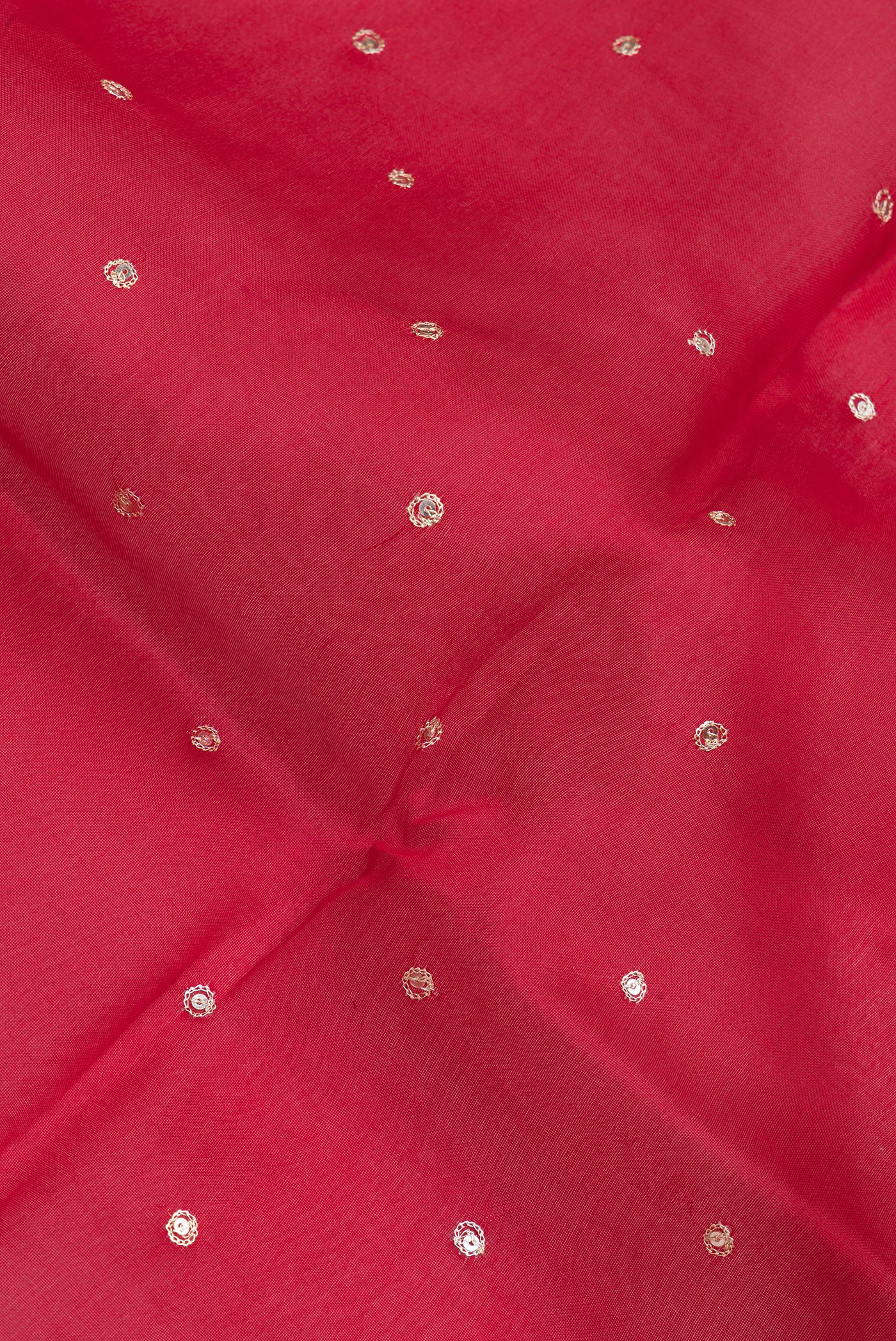 Close up of Deep Red Organza Silk Saree with Embroidery on the body and Embroidery Border.  displaying folds