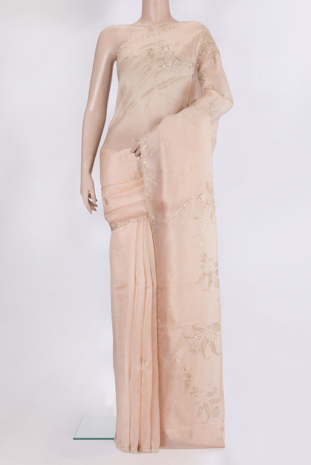 Rose Gold Organza Silk Saree with Embroidery on the body and Sequin Border.  displayed on a mannequin
