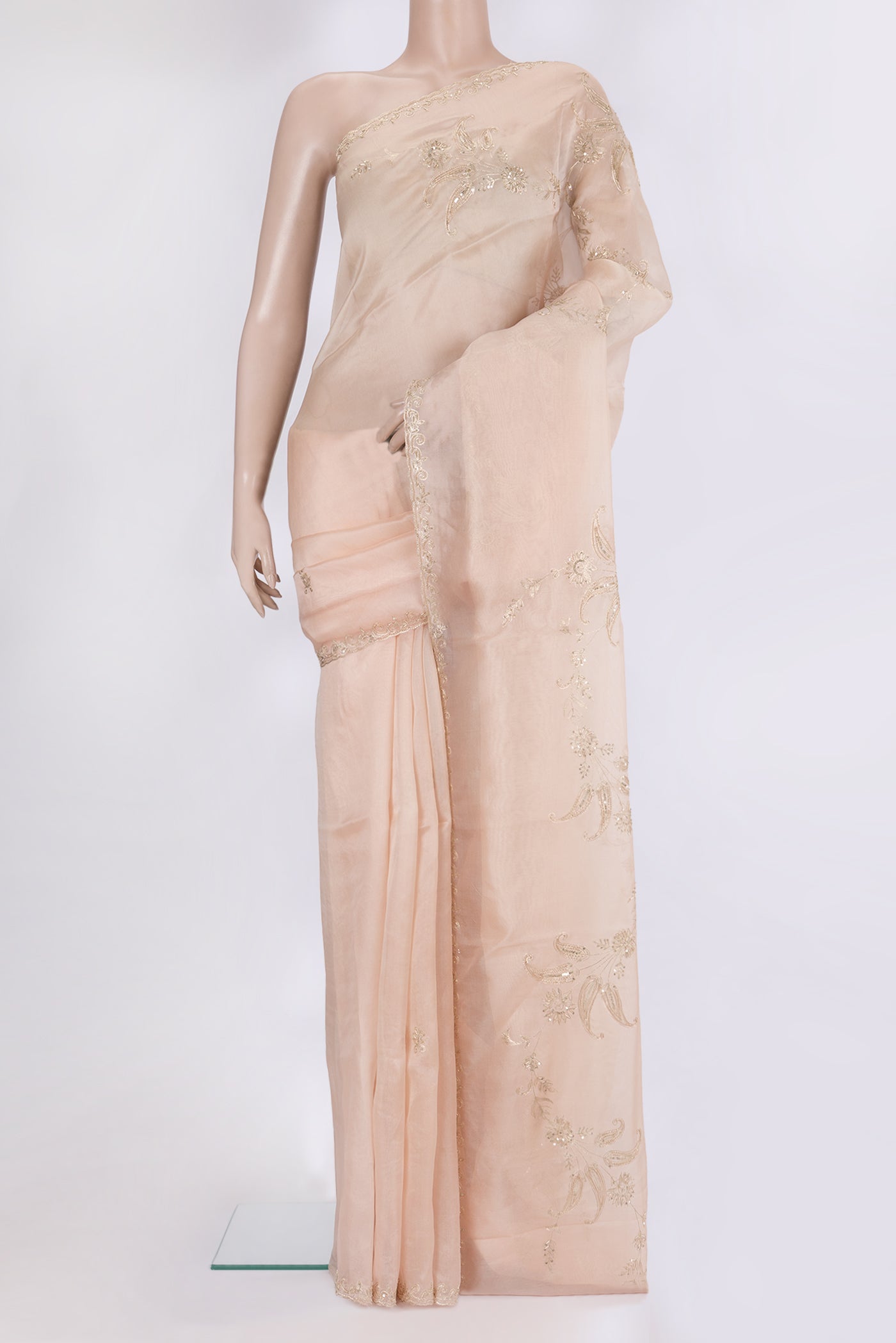 Rose Gold Organza Silk Saree with Embroidery on the body and Sequin Border.  displayed on a mannequin