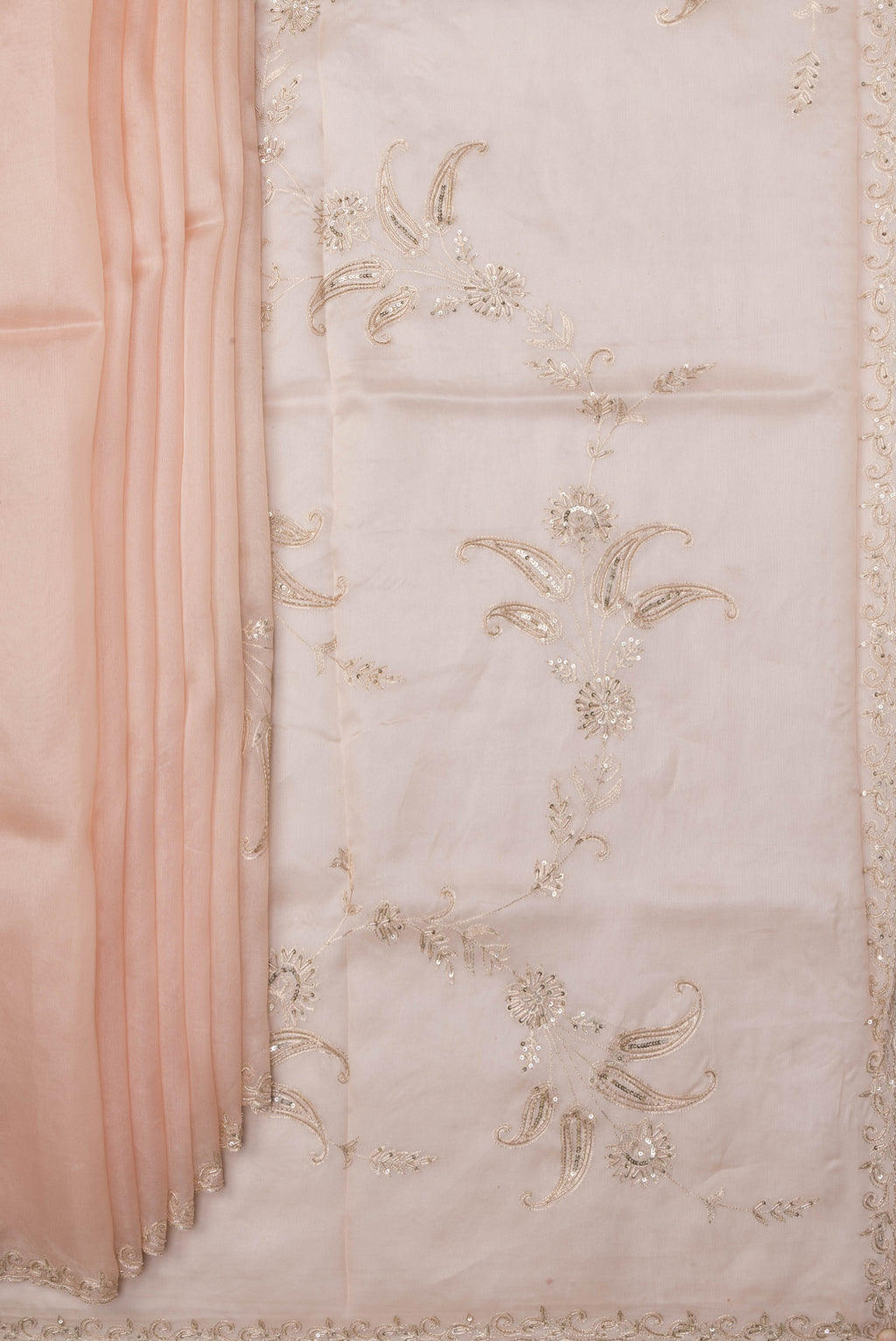 Pleats and pallu of Rose Gold Organza Silk Saree with Embroidery on the body and Sequin Border. 
