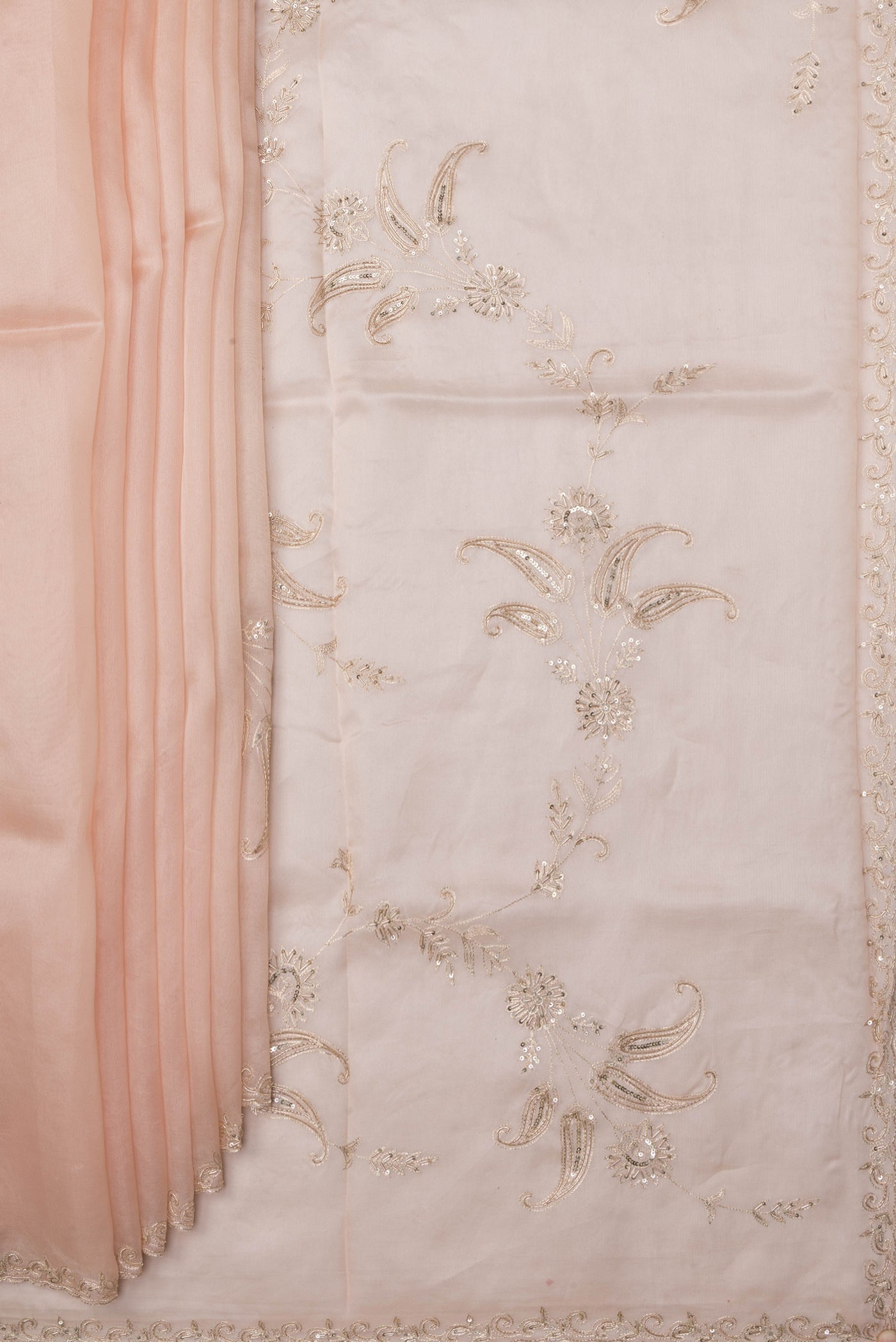 Pleats and pallu of Rose Gold Organza Silk Saree with Embroidery on the body and Sequin Border. 