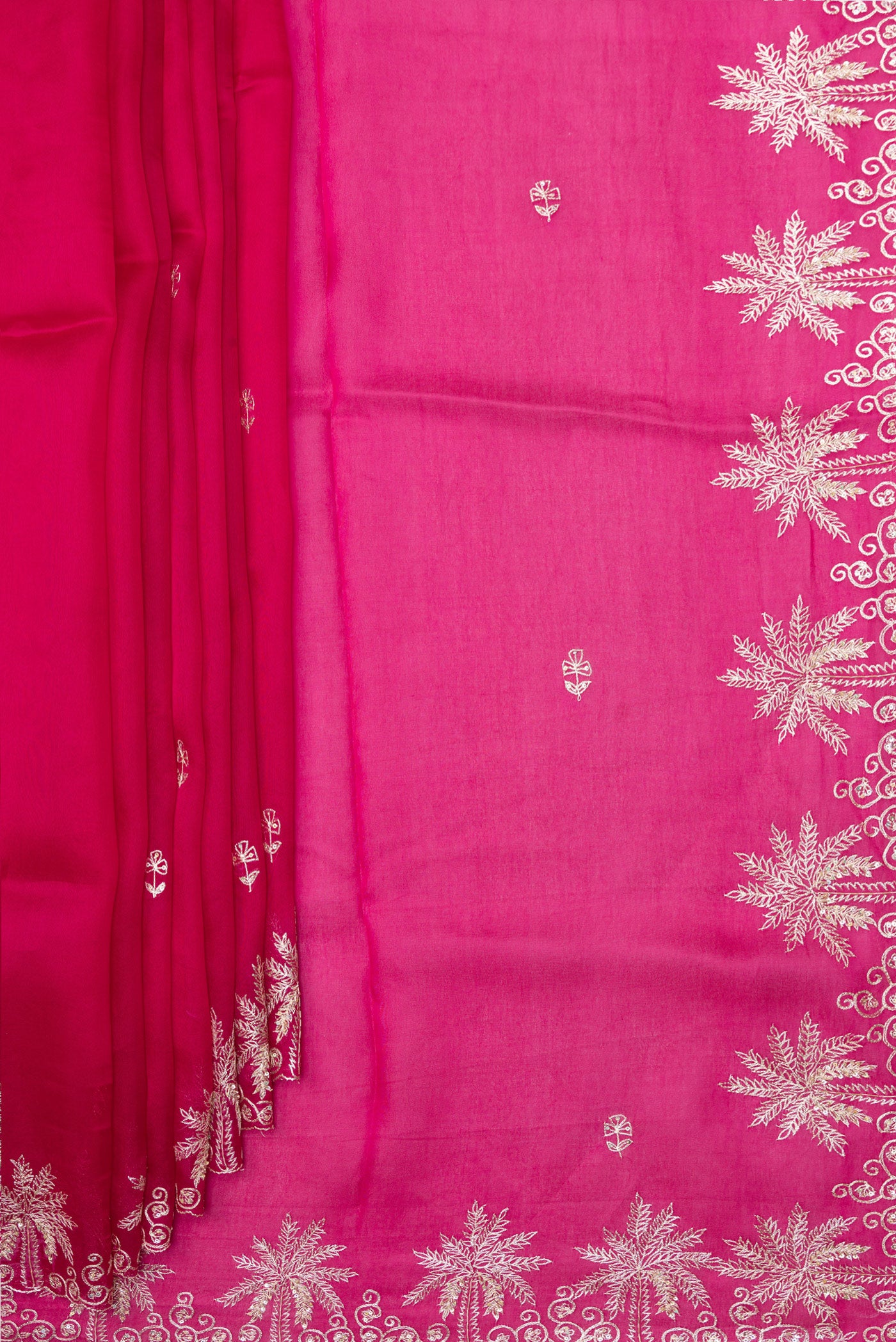Pleats and pallu of Dark Pink Organza Silk Saree with Embroidery on the body and Embroidery Border. 