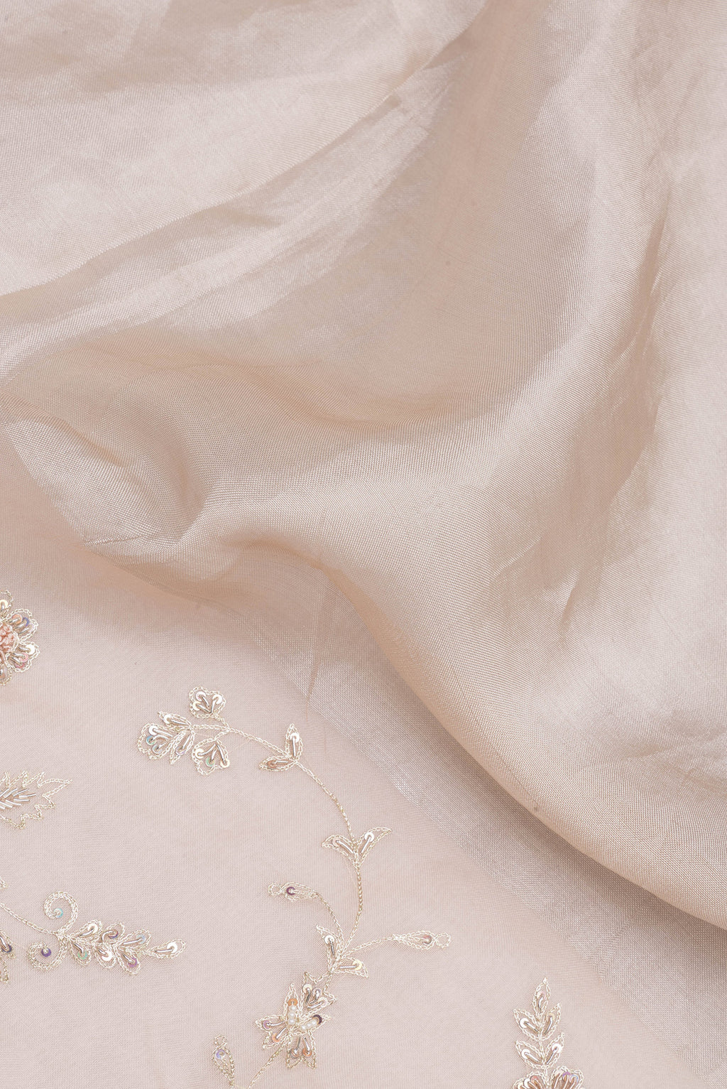 Close up of Golden Peach Organza Silk Saree with Embroidery on the body and Embroidery Border.  displaying folds