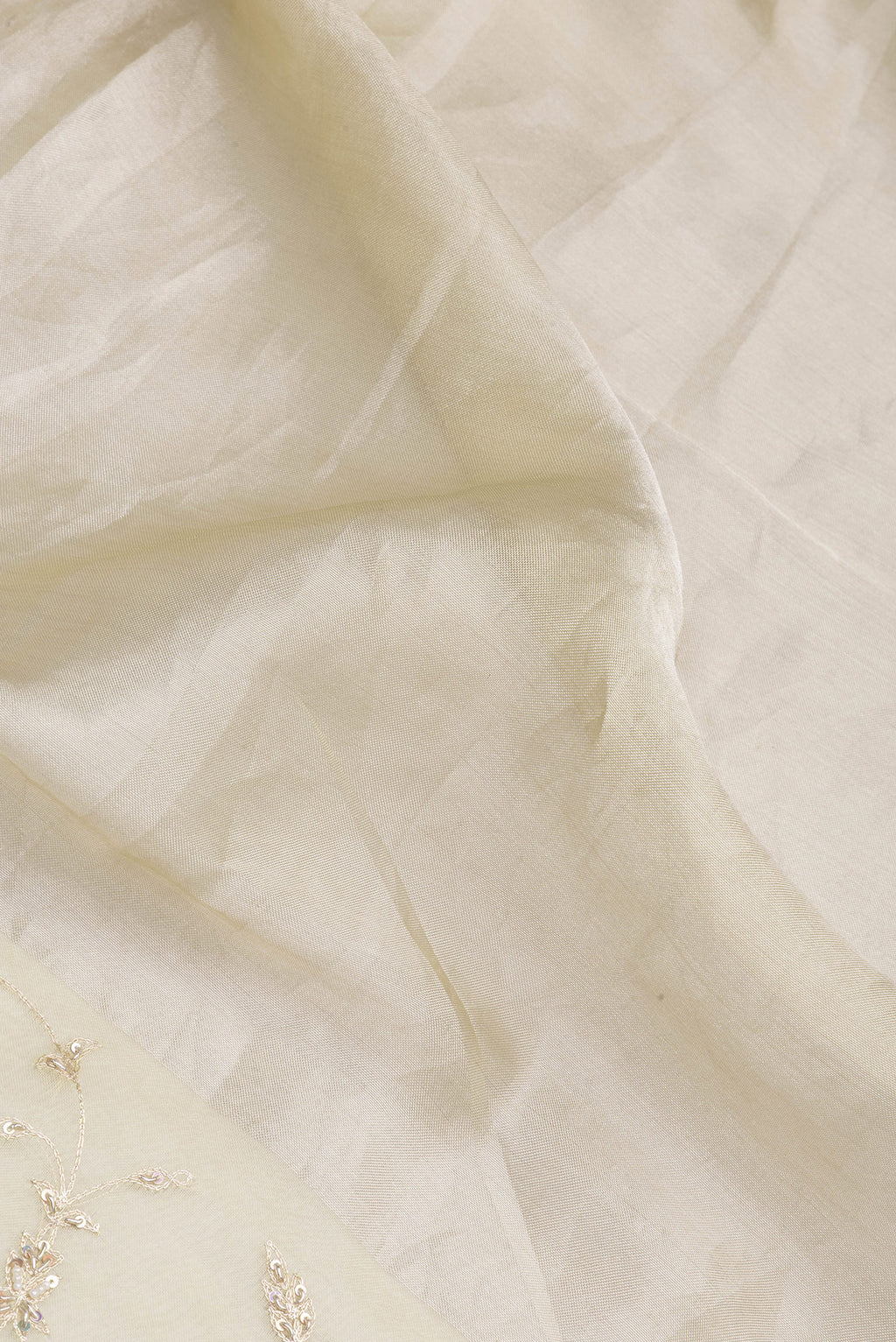 Close up of Lemon Yellow Organza Silk Saree with Embroidery on the body and Embroidery Border.  displaying folds