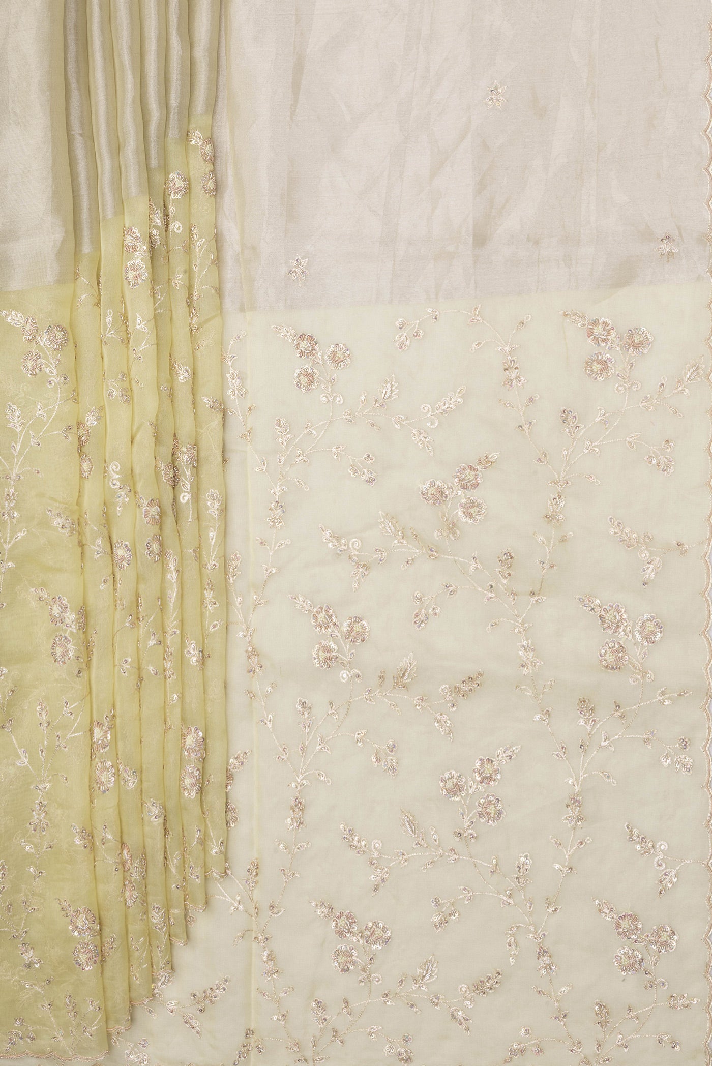 Pleats and pallu of Lemon Yellow Organza Silk Saree with Embroidery on the body and Embroidery Border. 