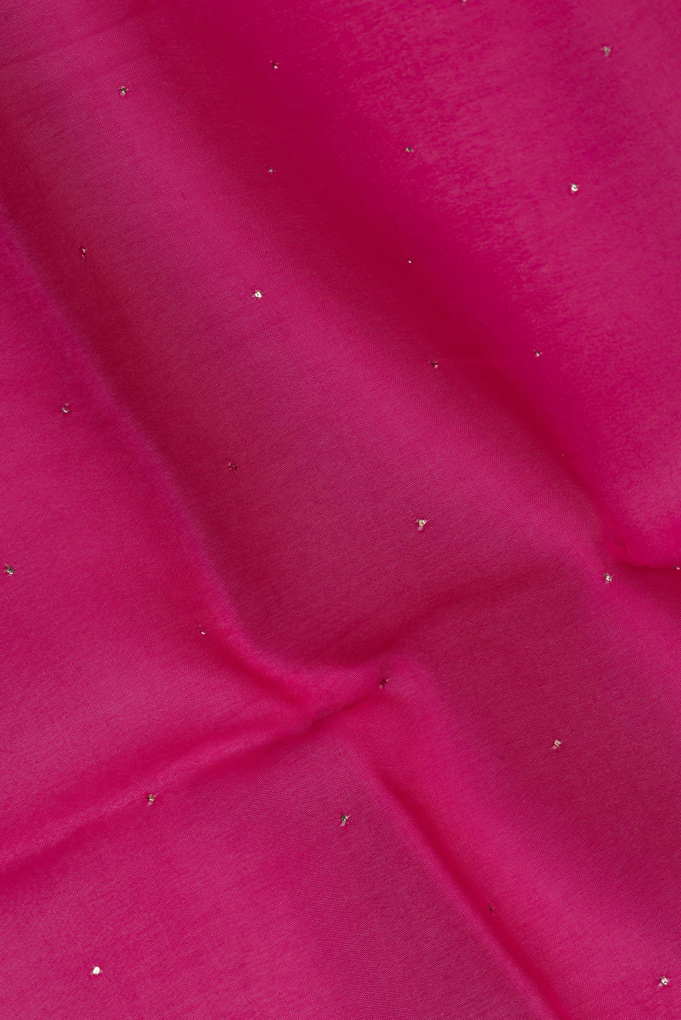 Close up of Dark Pink Organza Silk Saree with Embroidery on the body and Zari Border.  displaying folds