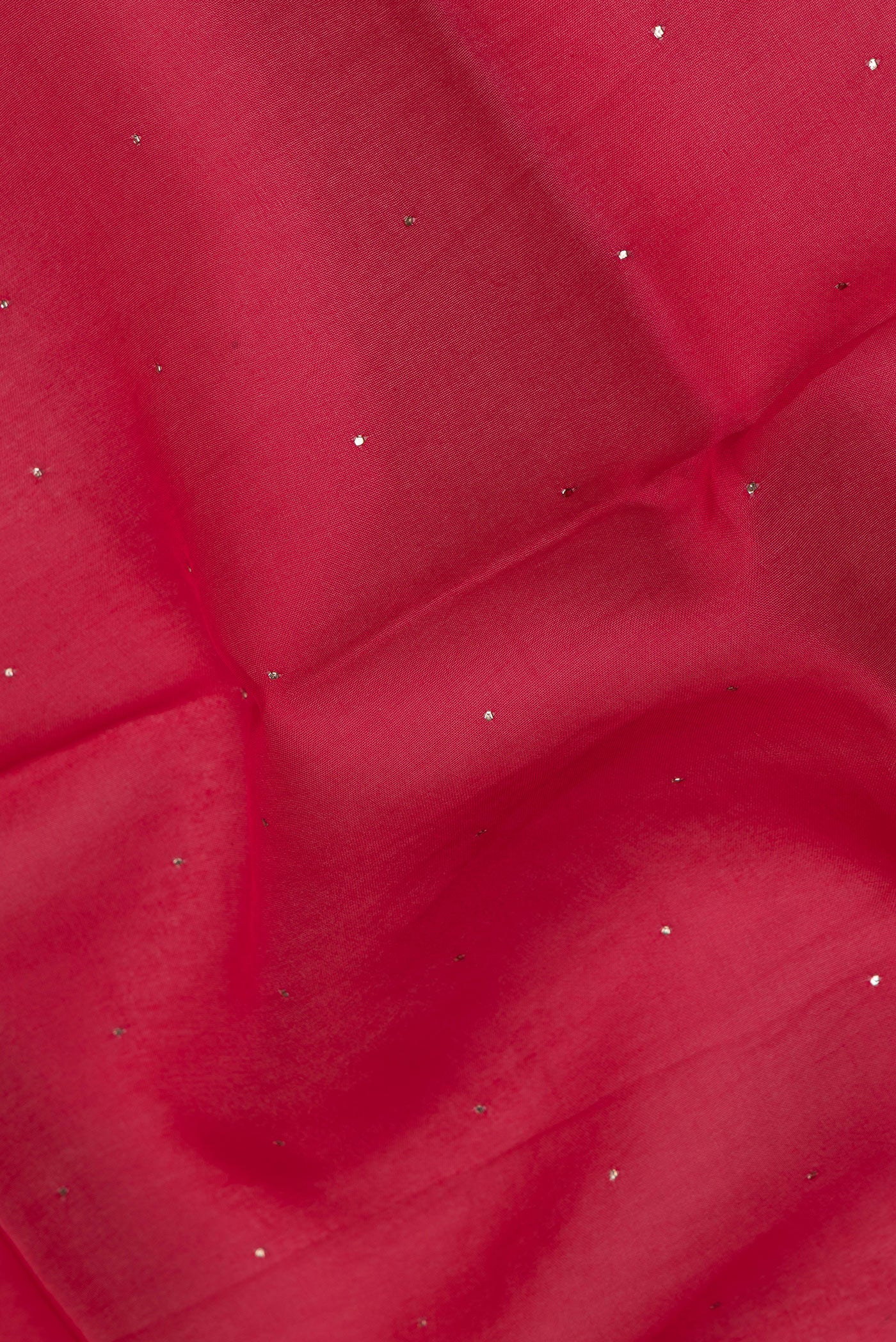Close up of Red Dual Tone Organza Silk Saree with Embroidery on the body and Zari Border.  displaying folds