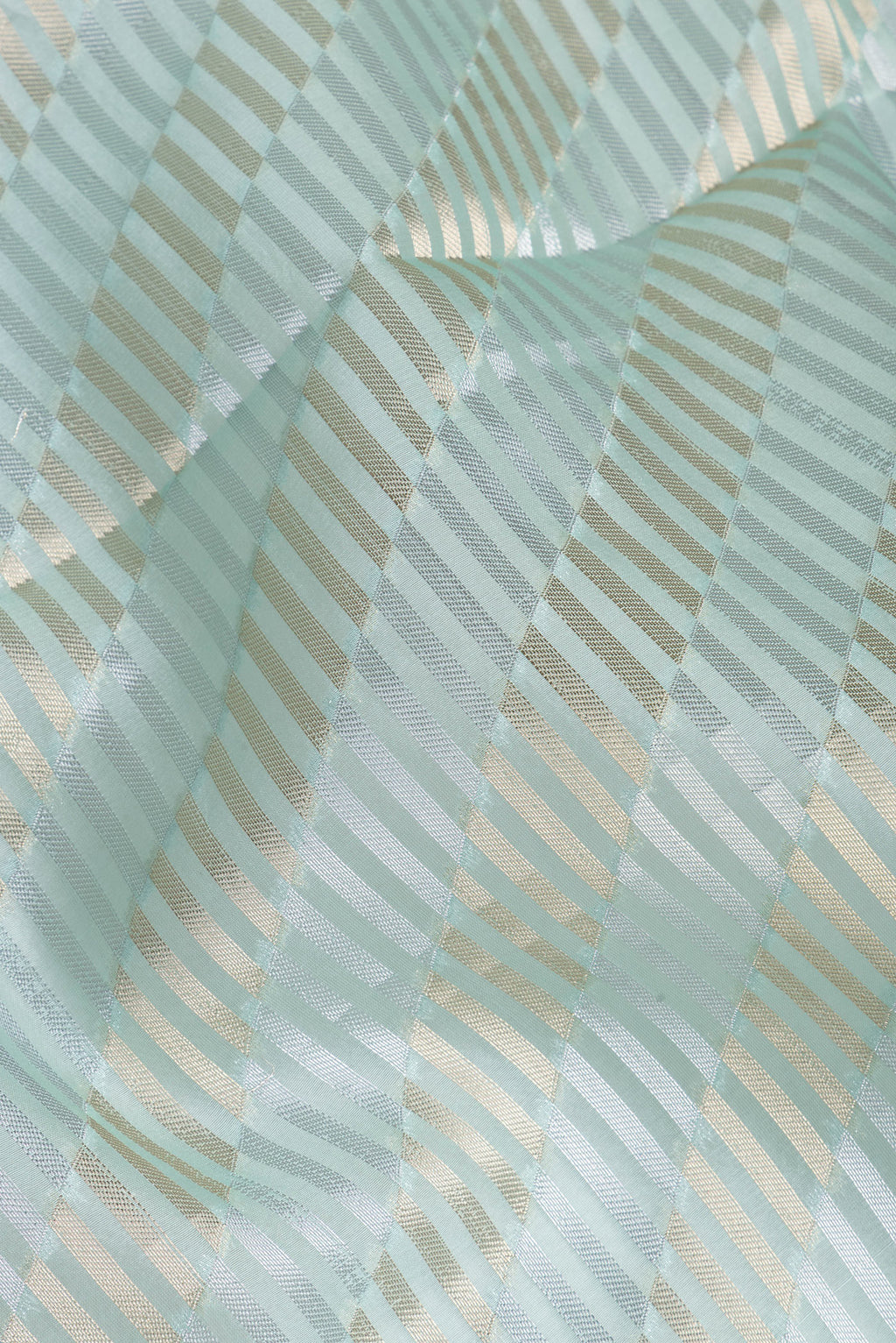 Close up of Sky Blue Organza Silk Saree with Zari Brocade on the body and Sequin Border.  displaying folds