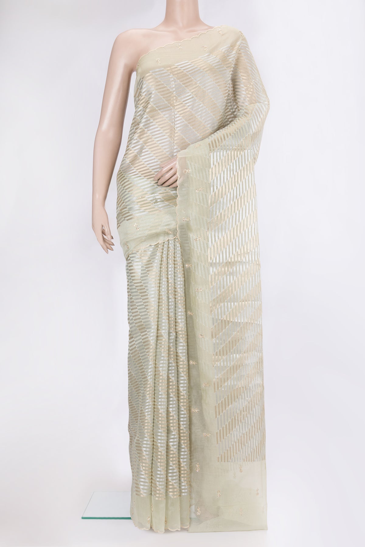 Pista Green Organza Silk Saree with Zari Brocade on the body and Sequin Border.  displayed on a mannequin