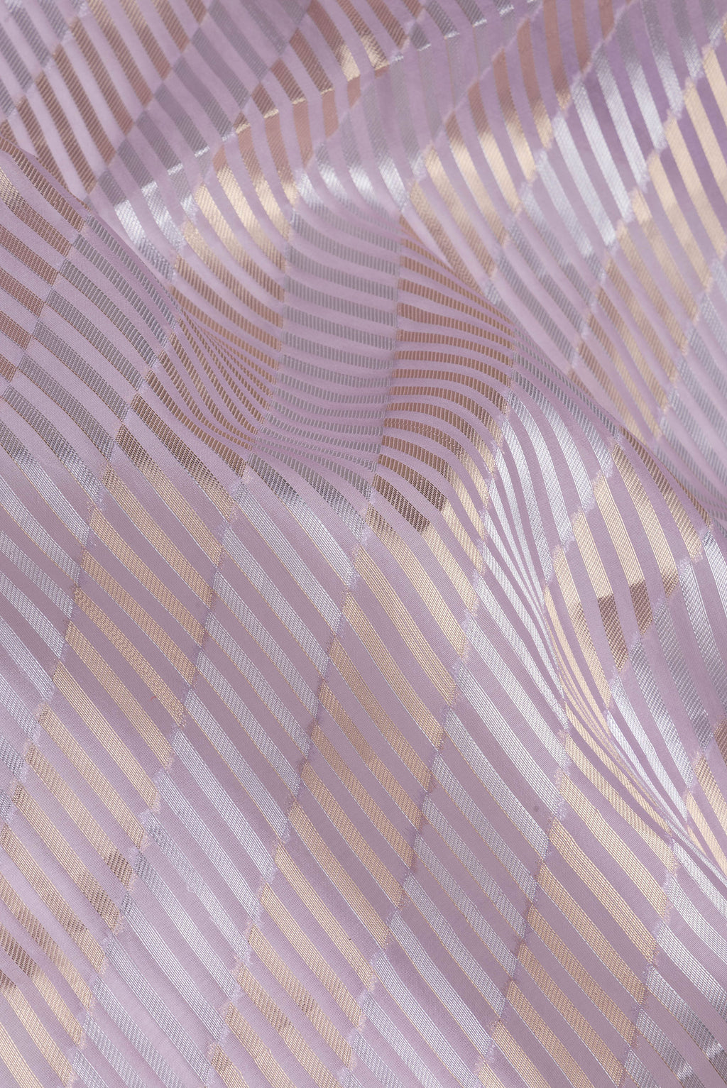 Close up of Lavender Organza Silk Saree with Zari Brocade on the body and Sequin Border.  displaying folds