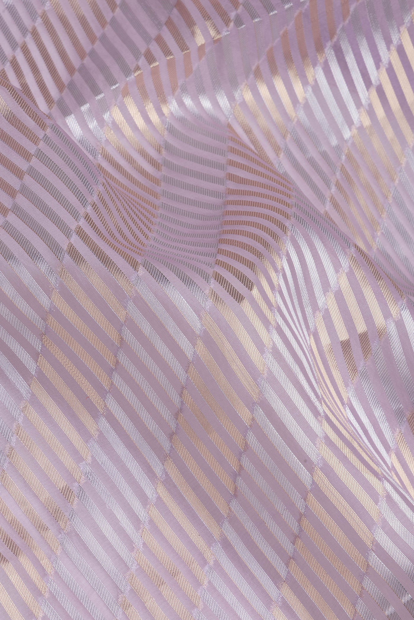 Close up of Lavender Organza Silk Saree with Zari Brocade on the body and Sequin Border.  displaying folds