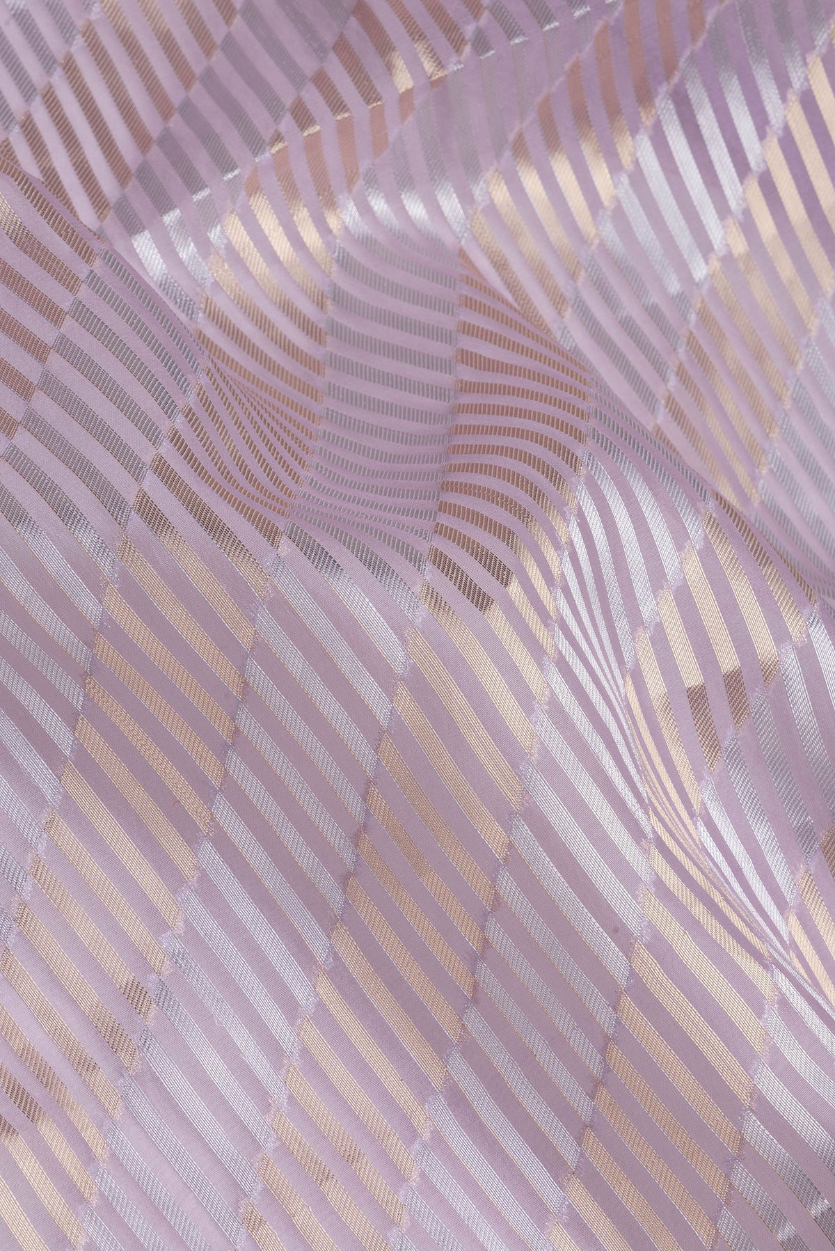 Close up of Lavender Organza Silk Saree with Zari Brocade on the body and Sequin Border.  displaying folds