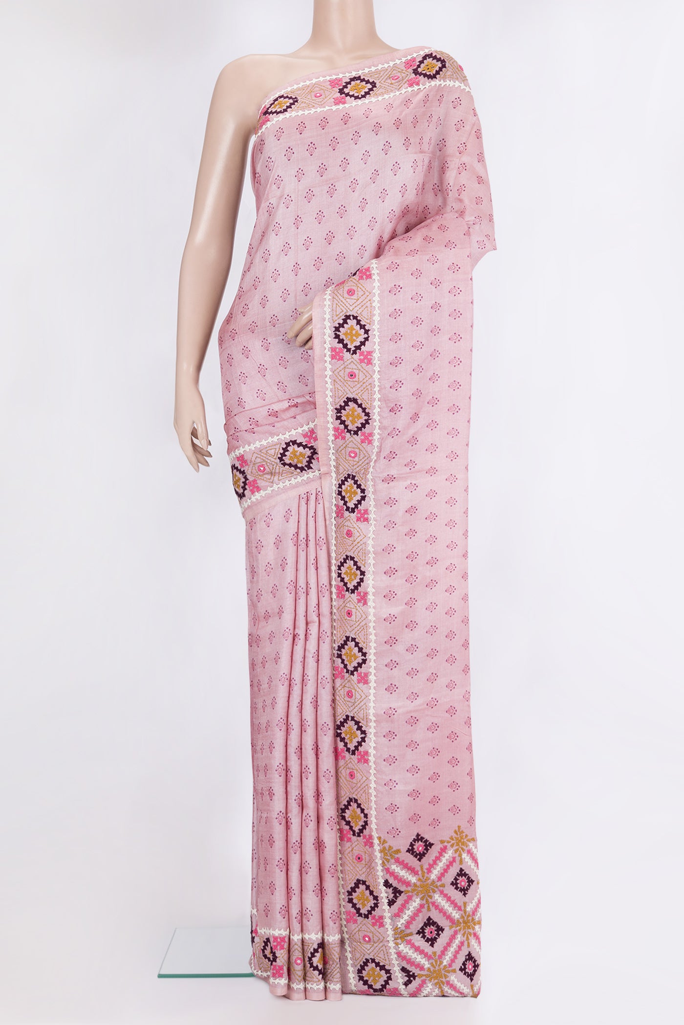 Pink Tussar Silk Saree with Printed design on the body and Embroidery Border.  displayed on a mannequin