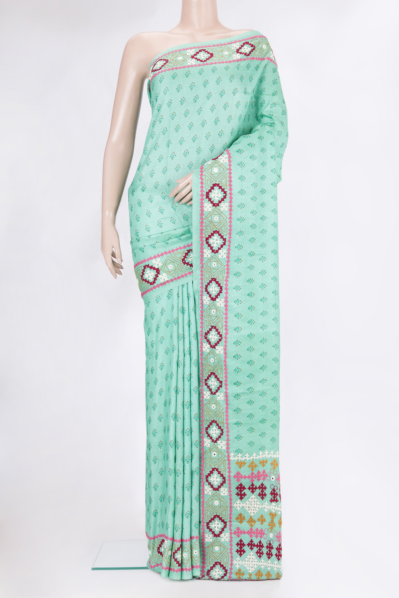 Sea Green Tussar Silk Saree with Printed design on the body and Embroidery Border.  displayed on a mannequin