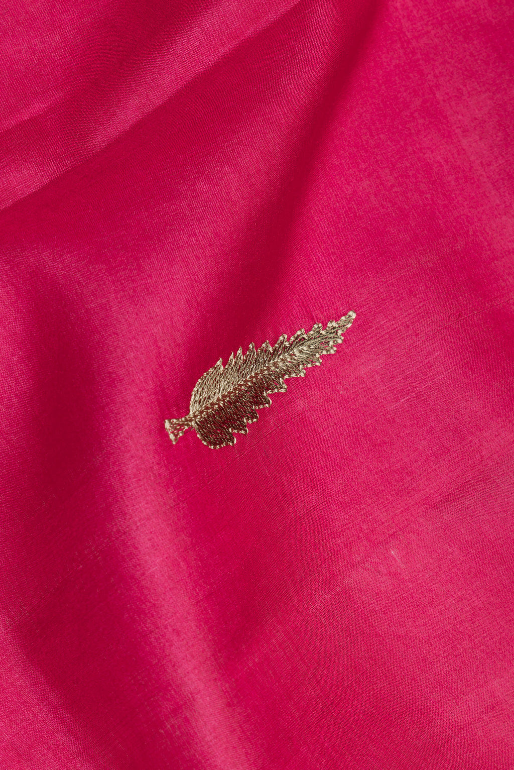 Close up of Dark Pink Tussar Silk Saree with Embroidery on the body and Zari Border.  displaying folds