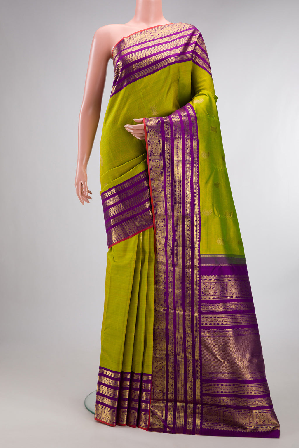Pure Silk Pure Zari Parrot Green Kanjivaram Saree with Zari Butta on the body and Fancy Border.  displayed on a mannequin