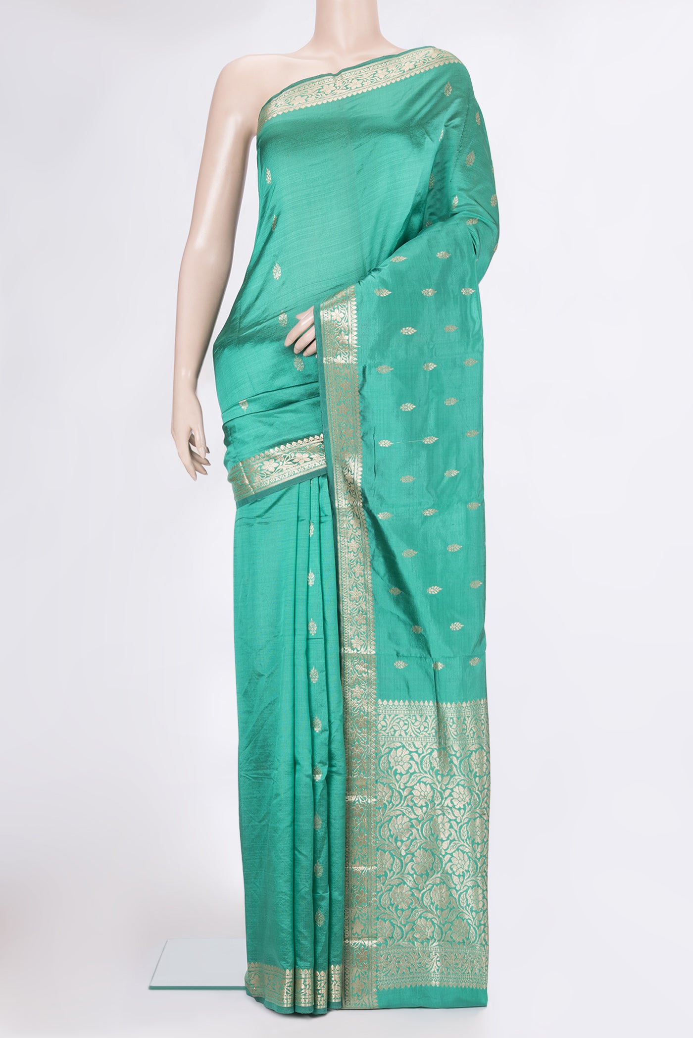 Green Banarasi Silk Saree with Zari Butta on the body and Zari Border.  displayed on a mannequin