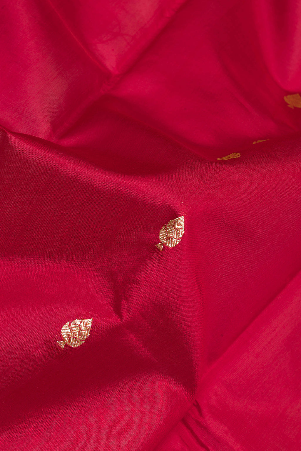 Close up of Maroon Banarasi Silk Saree with Zari Butta on the body and Zari Border.  displaying folds